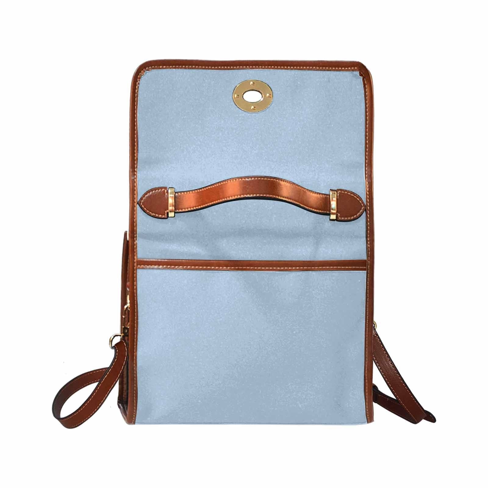 Serenity Blue Canvas Bag with brown strap, showcasing its waterproof material and stylish design.