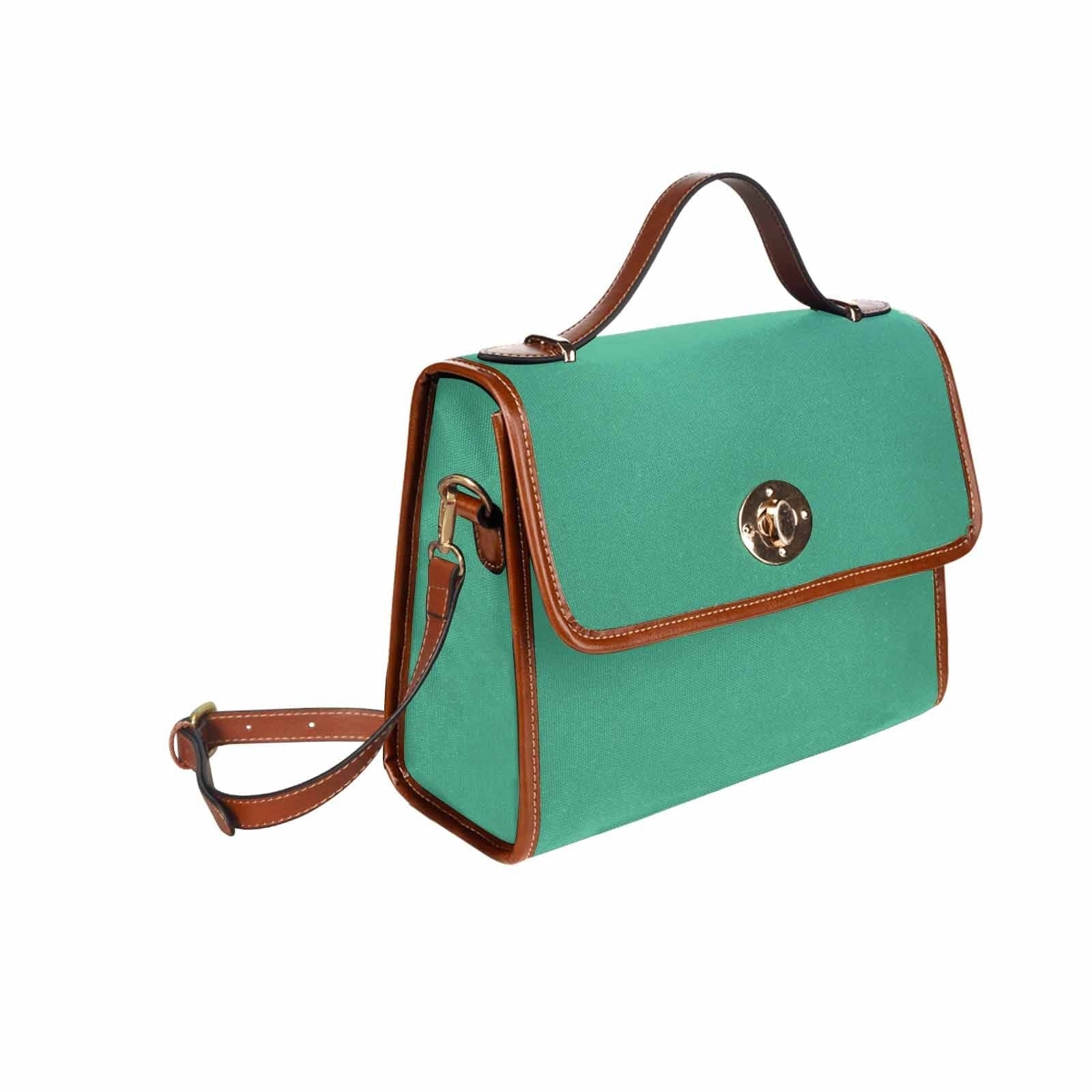 Spearmint Green Canvas Bag with brown strap, featuring two interior pockets and a removable adjustable shoulder strap.