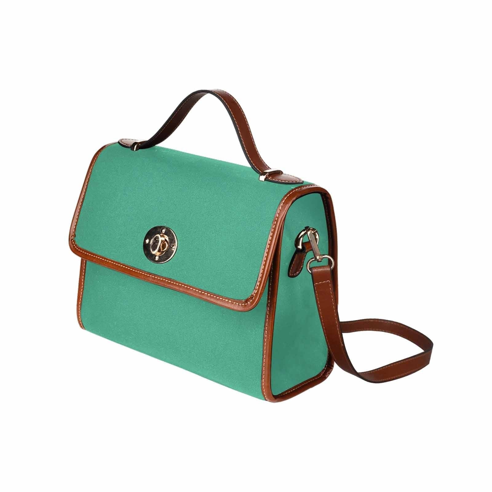 Spearmint Green Canvas Bag with brown strap, featuring two interior pockets and a removable adjustable shoulder strap.