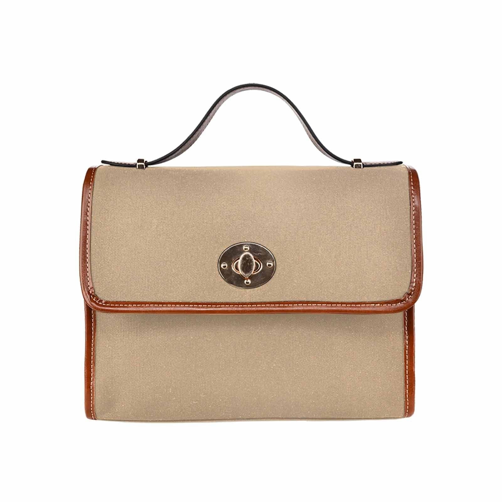 Tan brown canvas bag with brown strap, featuring two interior pockets and a zipper pocket.