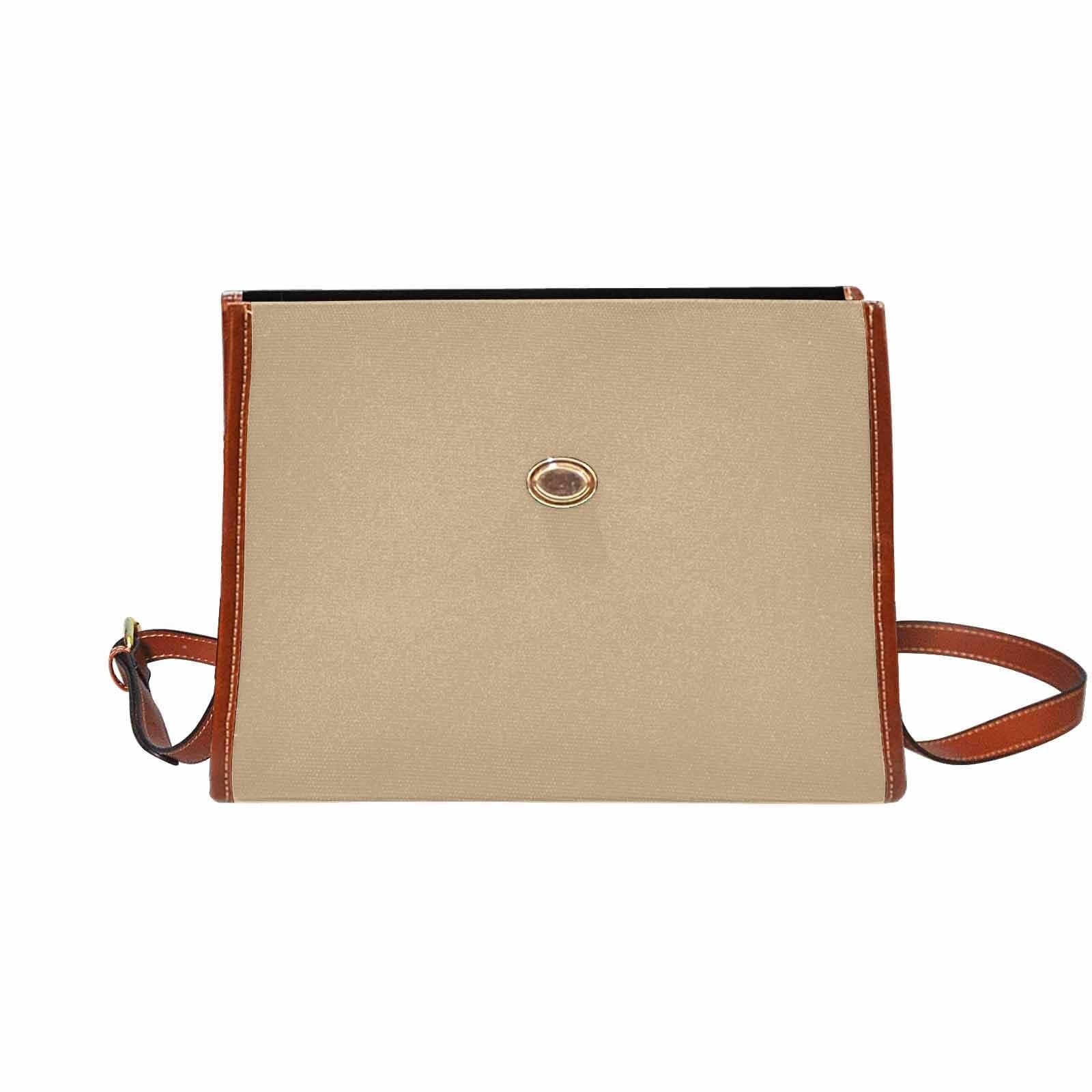 Tan brown canvas bag with brown strap, featuring two interior pockets and a zipper pocket.