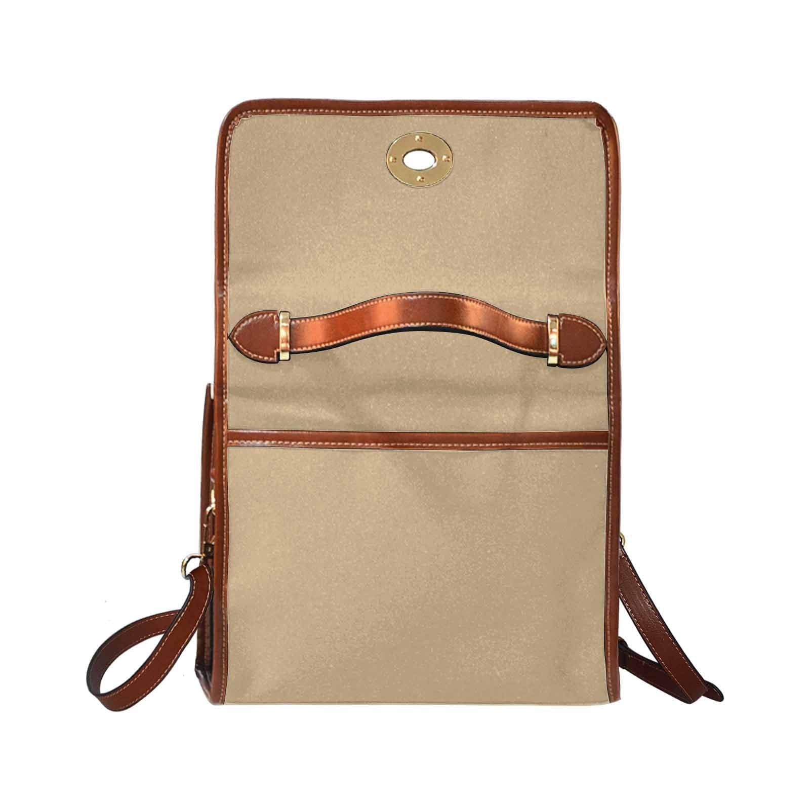 Tan brown canvas bag with brown strap, featuring two interior pockets and a zipper pocket.