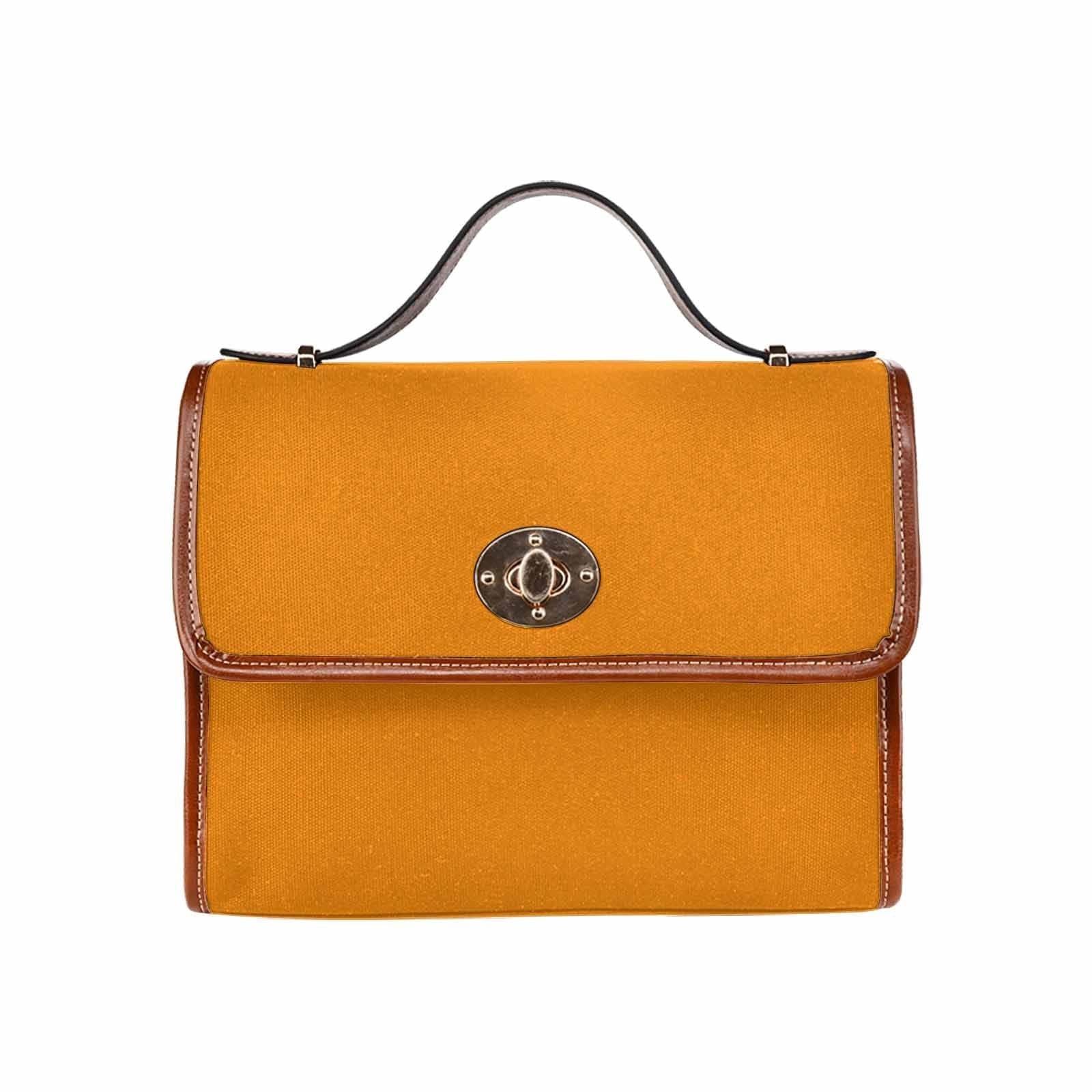 Stylish tangerine orange canvas bag with brown strap, featuring two interior pockets and a removable adjustable shoulder strap.