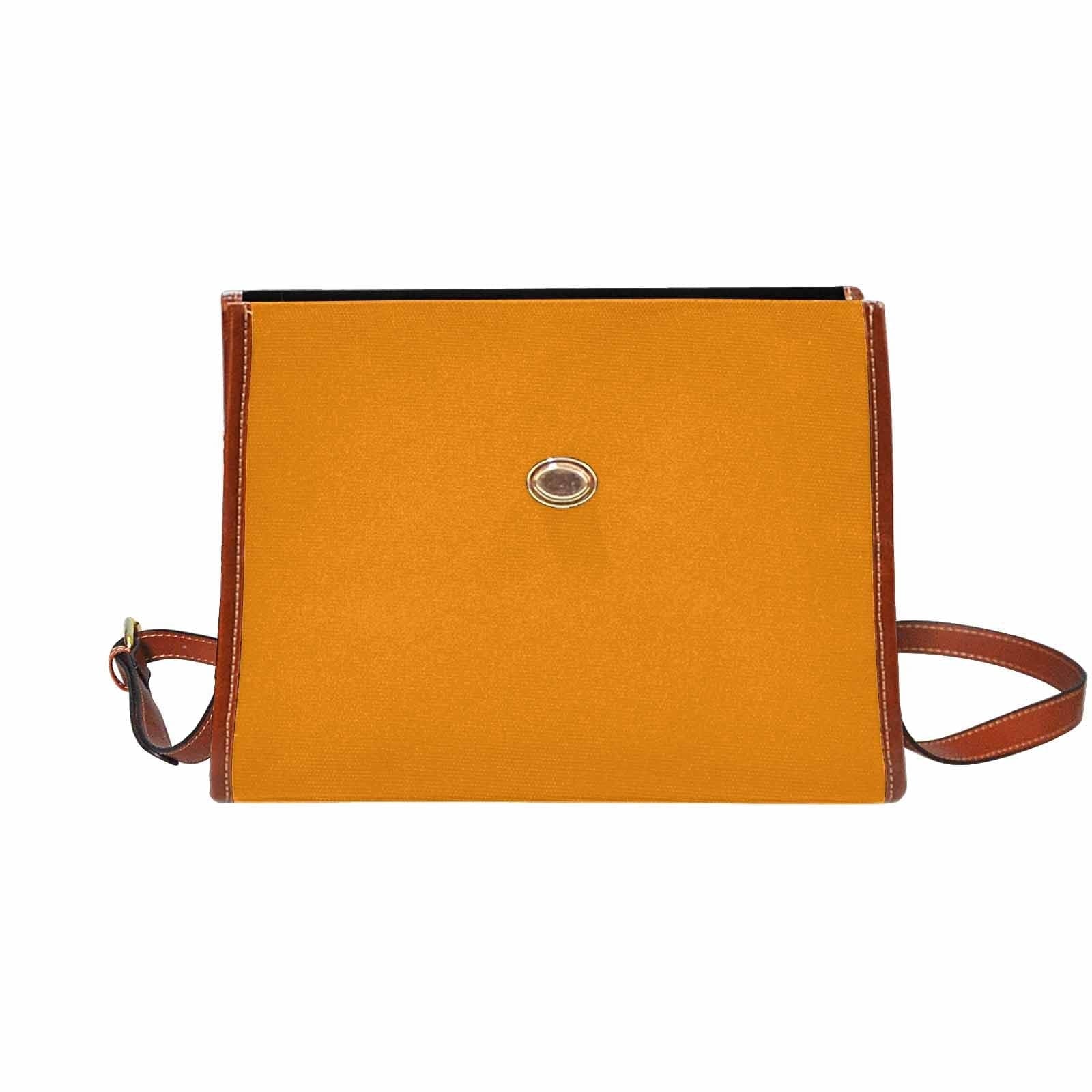 Stylish tangerine orange canvas bag with brown strap, featuring two interior pockets and a removable adjustable shoulder strap.