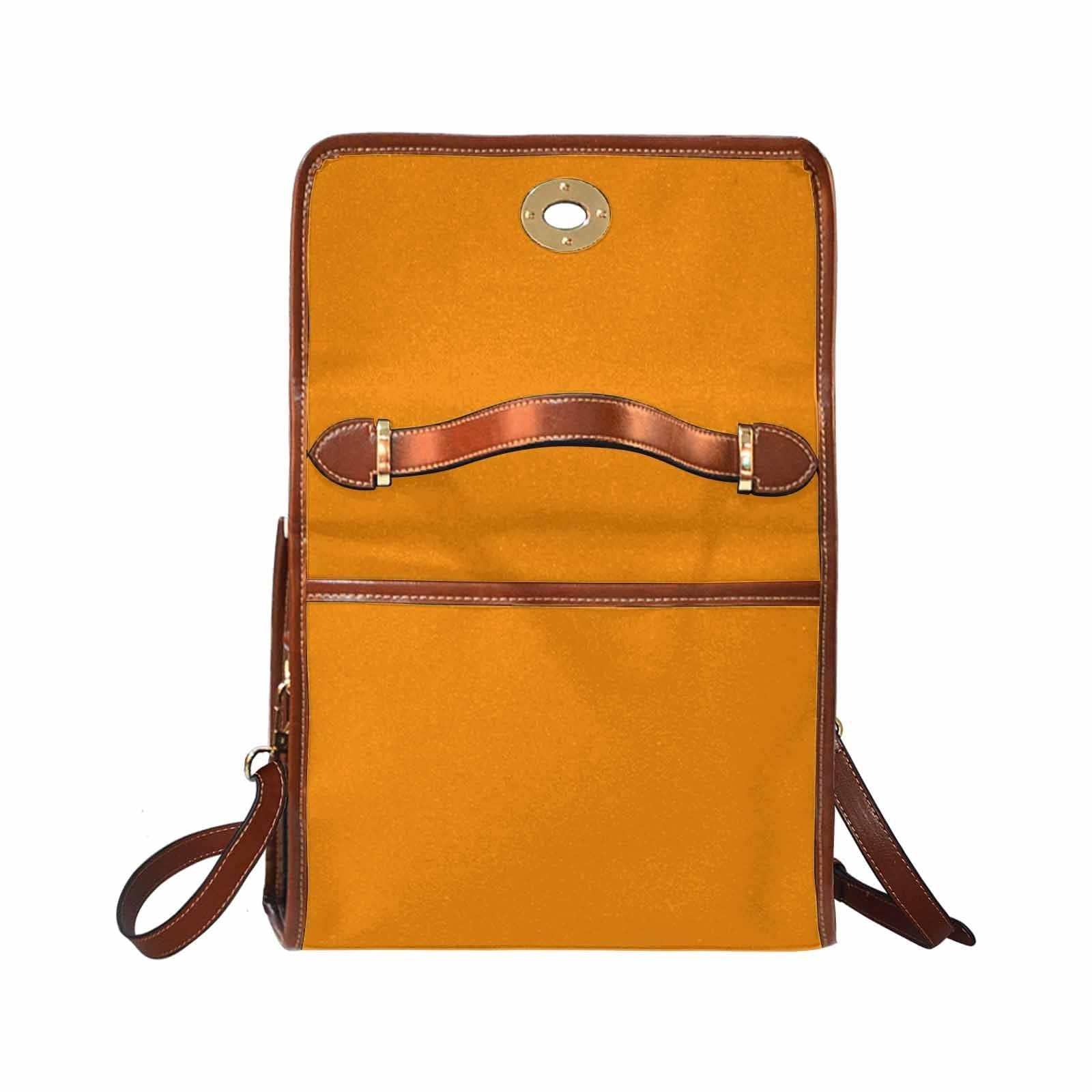 Stylish tangerine orange canvas bag with brown strap, featuring two interior pockets and a removable adjustable shoulder strap.