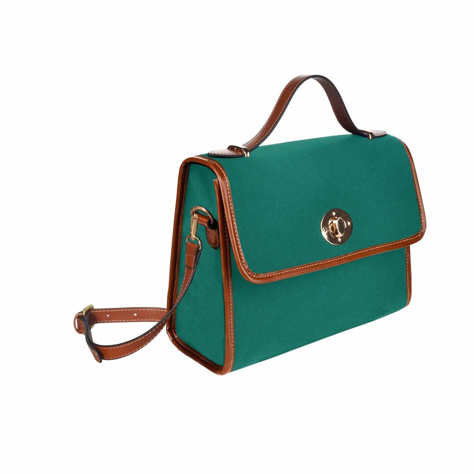 Teal green canvas bag with brown strap, featuring two interior pockets and a zipper pocket, perfect for versatile use.