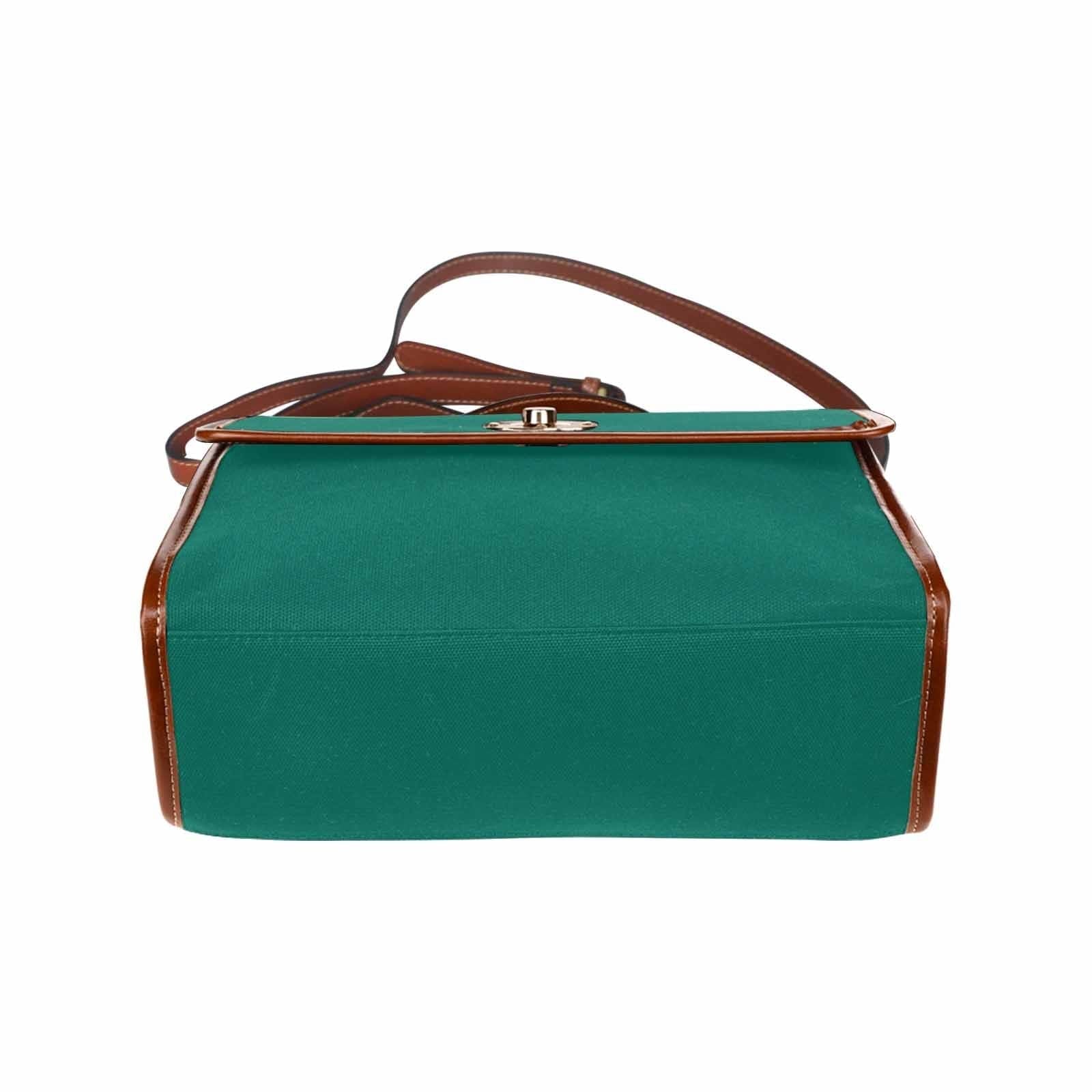 Teal green canvas bag with brown strap, featuring two interior pockets and a zipper pocket, perfect for versatile use.