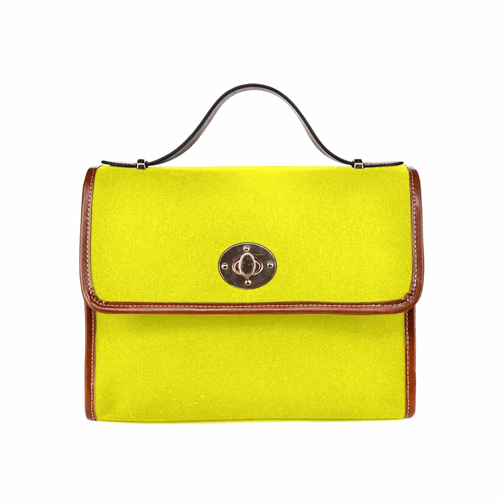 A vibrant yellow canvas bag with a brown adjustable shoulder strap, featuring two interior pockets and a zipper pocket, perfect for everyday use.