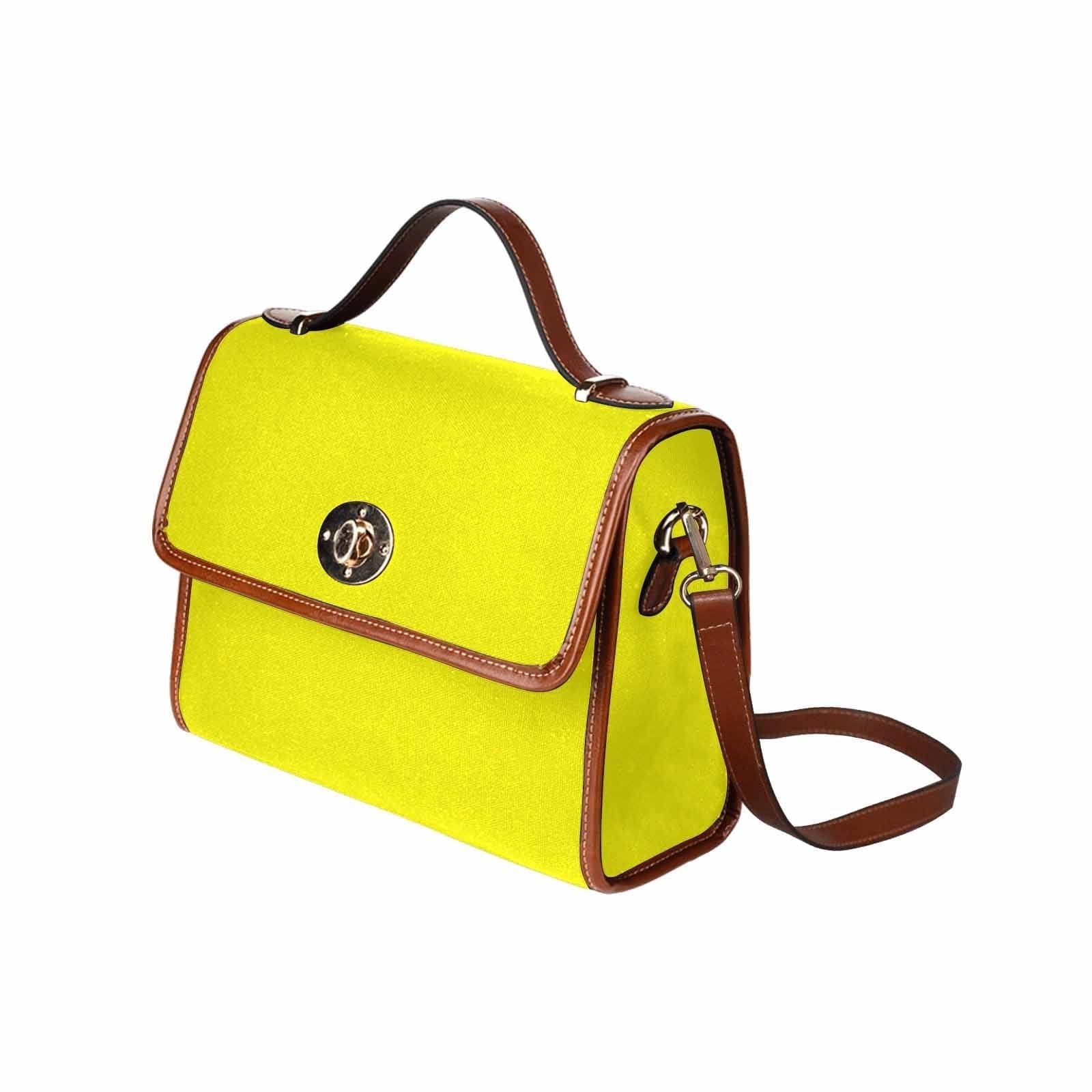 A vibrant yellow canvas bag with a brown adjustable shoulder strap, featuring two interior pockets and a zipper pocket, perfect for everyday use.