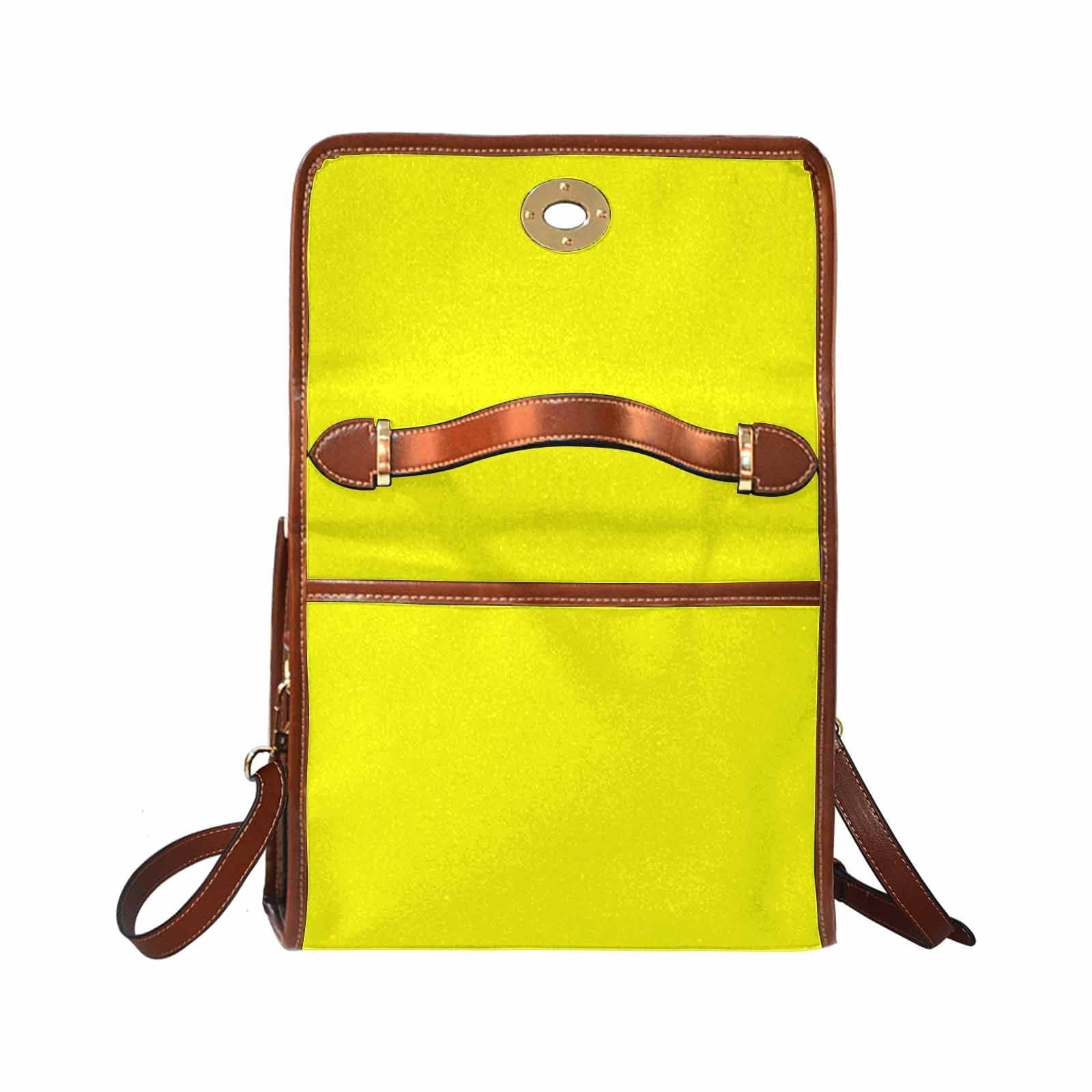 A vibrant yellow canvas bag with a brown adjustable shoulder strap, featuring two interior pockets and a zipper pocket, perfect for everyday use.