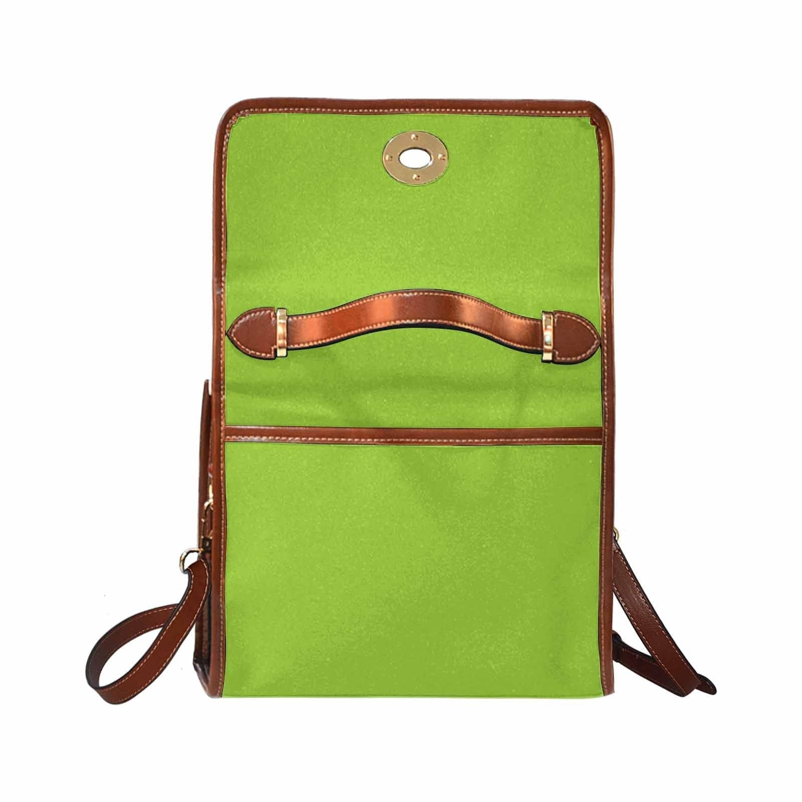 Yellow green canvas bag with brown strap, featuring two interior pockets and adjustable shoulder strap, perfect for various uses.