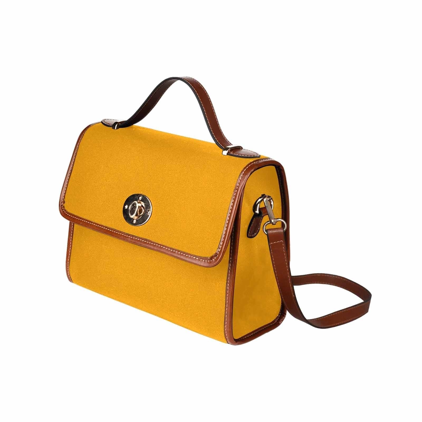 Bright orange canvas handbag with a brown crossbody strap, featuring two interior pockets and a zipper pocket.