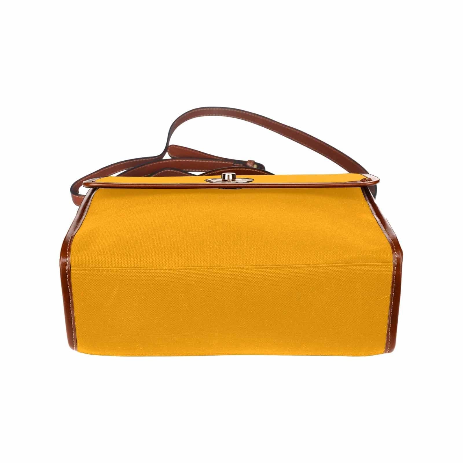 Bright orange canvas handbag with a brown crossbody strap, featuring two interior pockets and a zipper pocket.