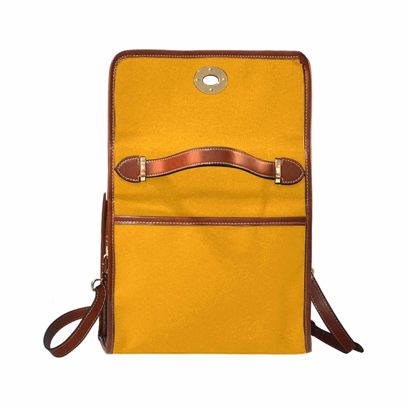 Bright orange canvas handbag with a brown crossbody strap, featuring two interior pockets and a zipper pocket.