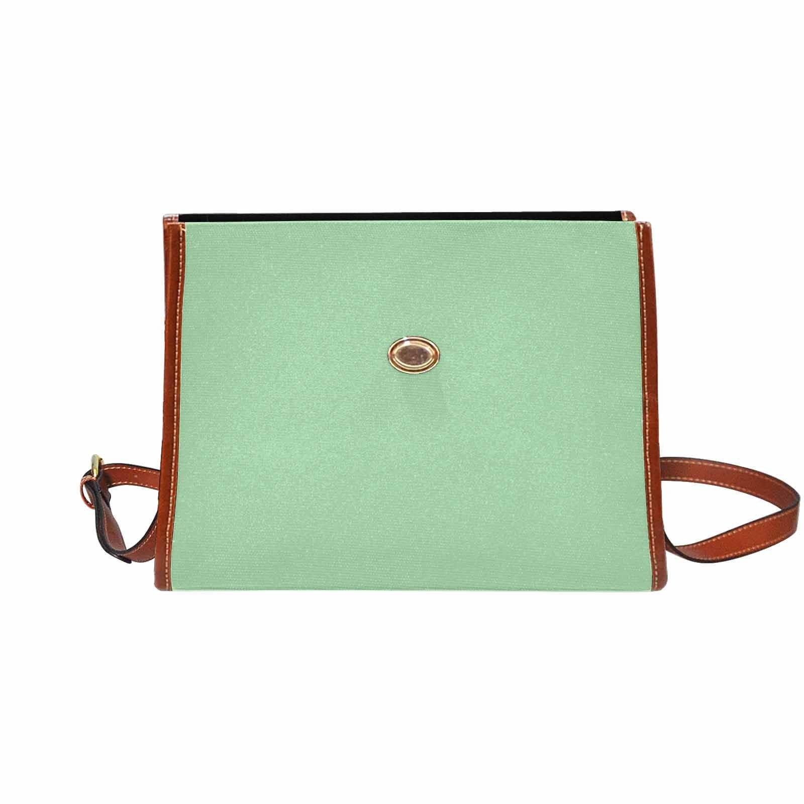 Celadon green canvas handbag with brown crossbody strap, featuring two interior pockets and a zipper pocket.