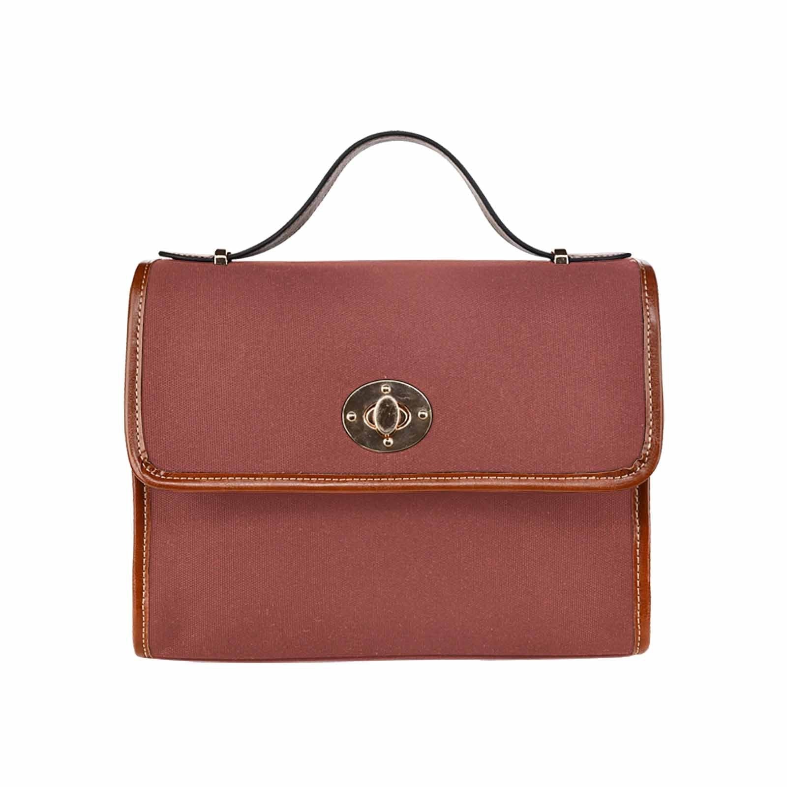 Cognac red waterproof canvas handbag with brown crossbody strap, featuring two interior pockets and a zipper pocket.