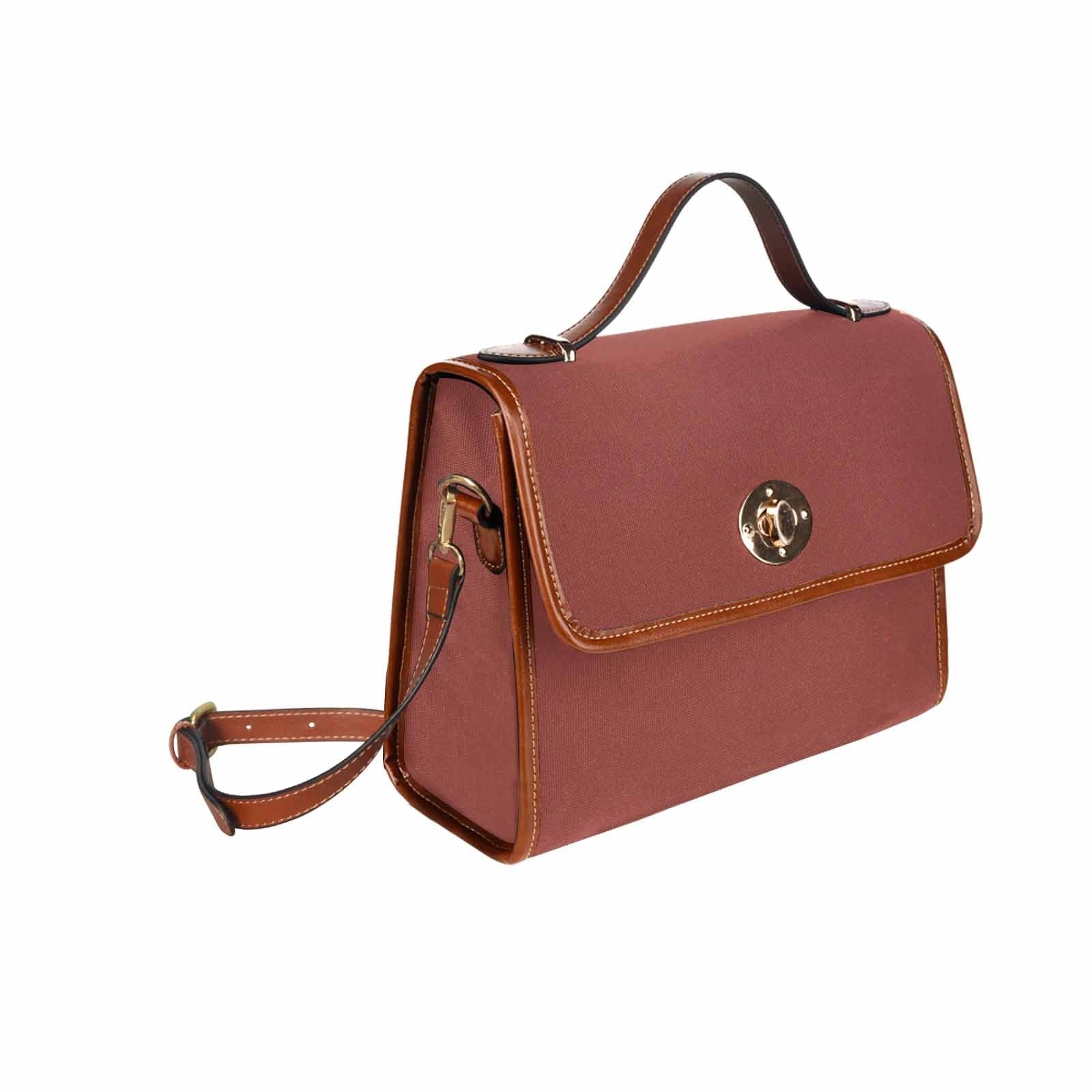 Cognac red waterproof canvas handbag with brown crossbody strap, featuring two interior pockets and a zipper pocket.