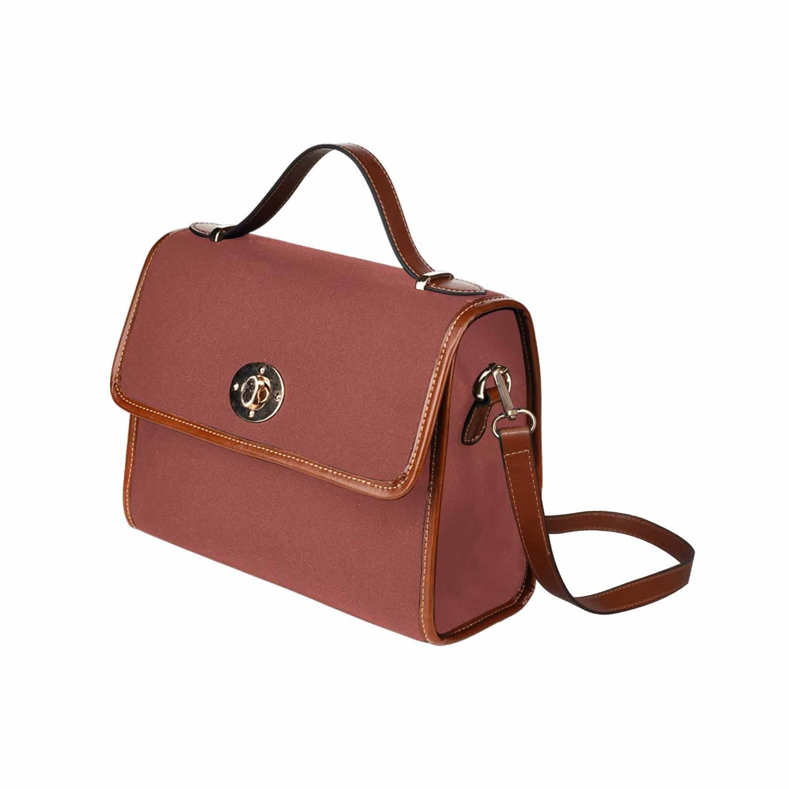 Cognac red waterproof canvas handbag with brown crossbody strap, featuring two interior pockets and a zipper pocket.