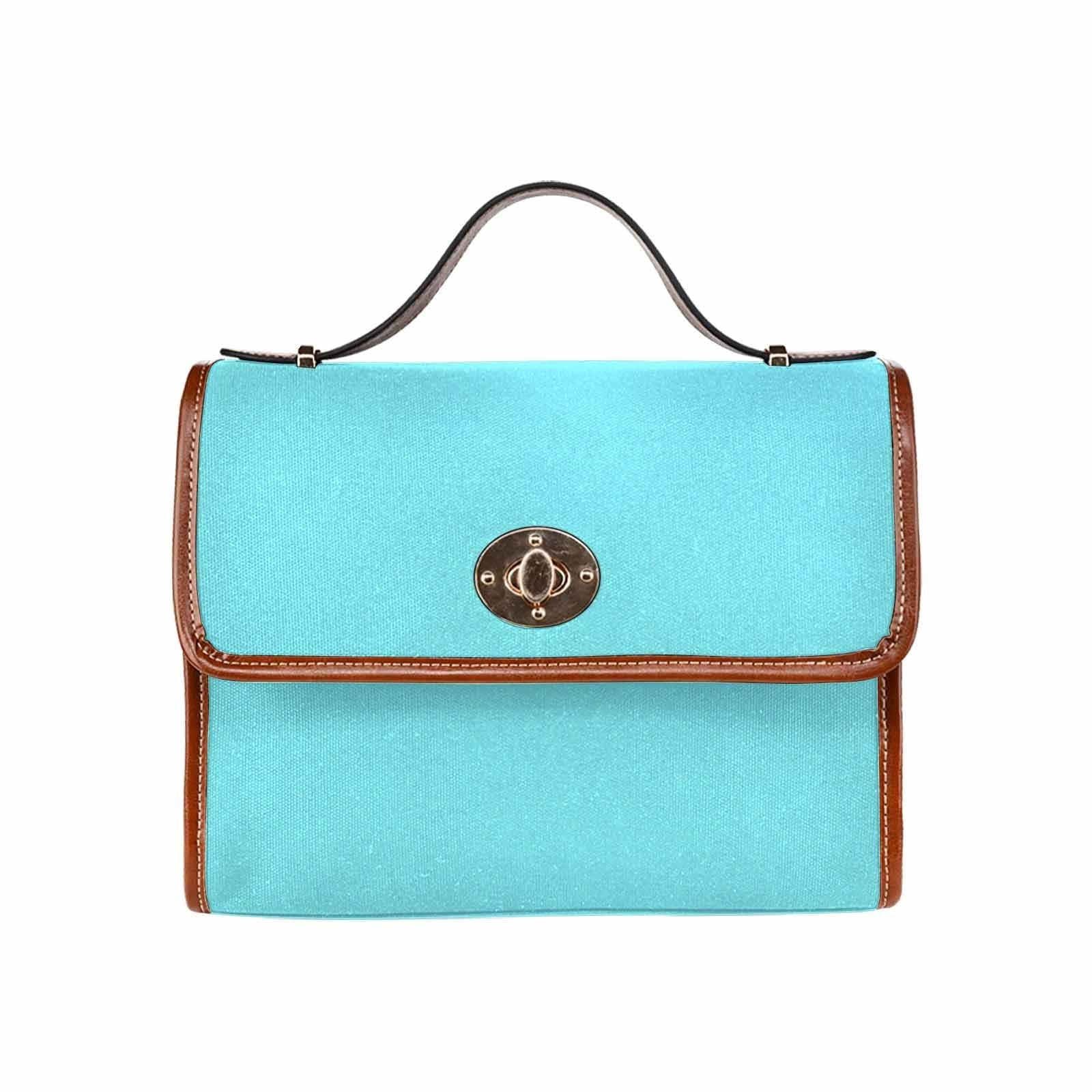 Electric blue canvas handbag with brown crossbody strap, featuring two interior pockets and a zipper pocket.