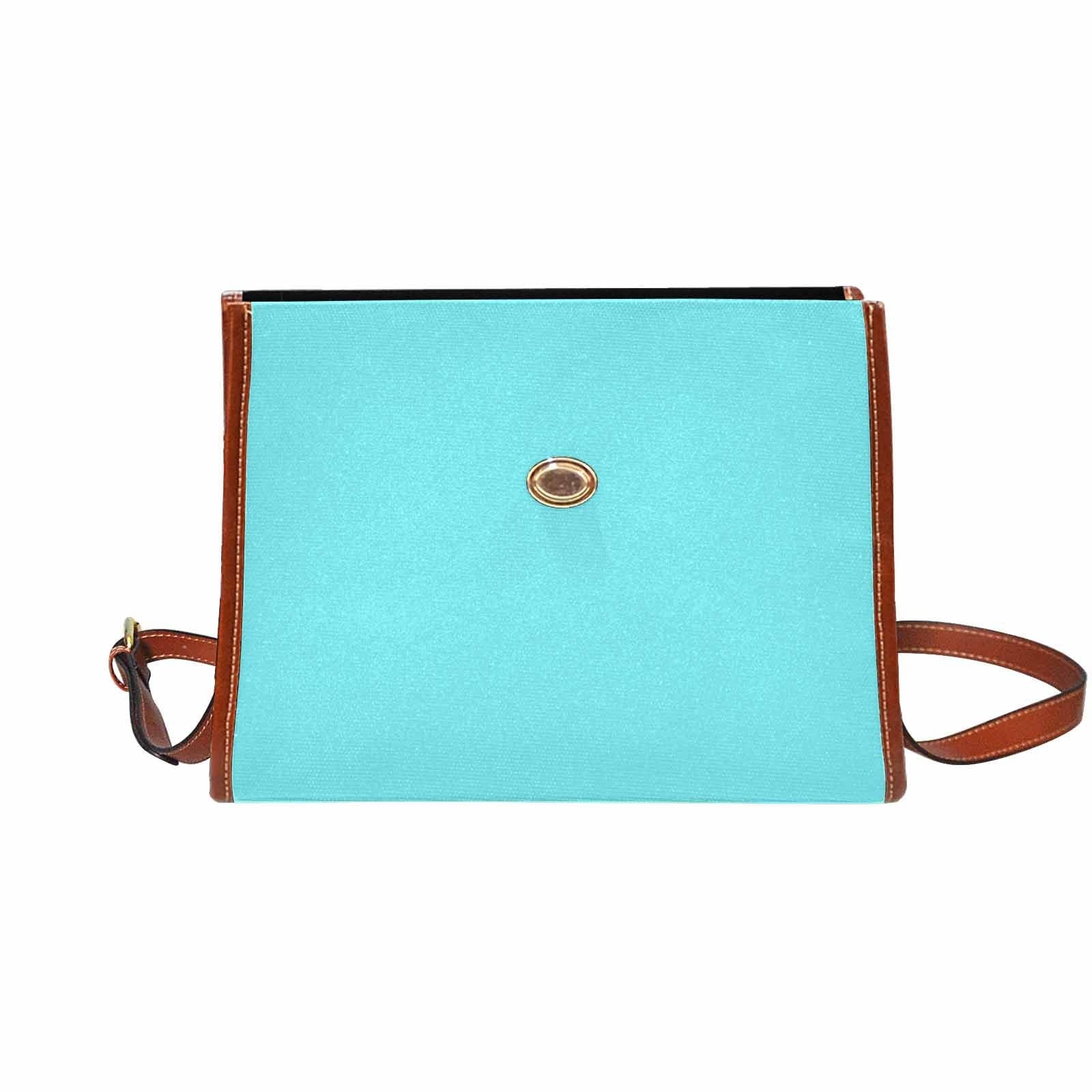 Electric blue canvas handbag with brown crossbody strap, featuring two interior pockets and a zipper pocket.