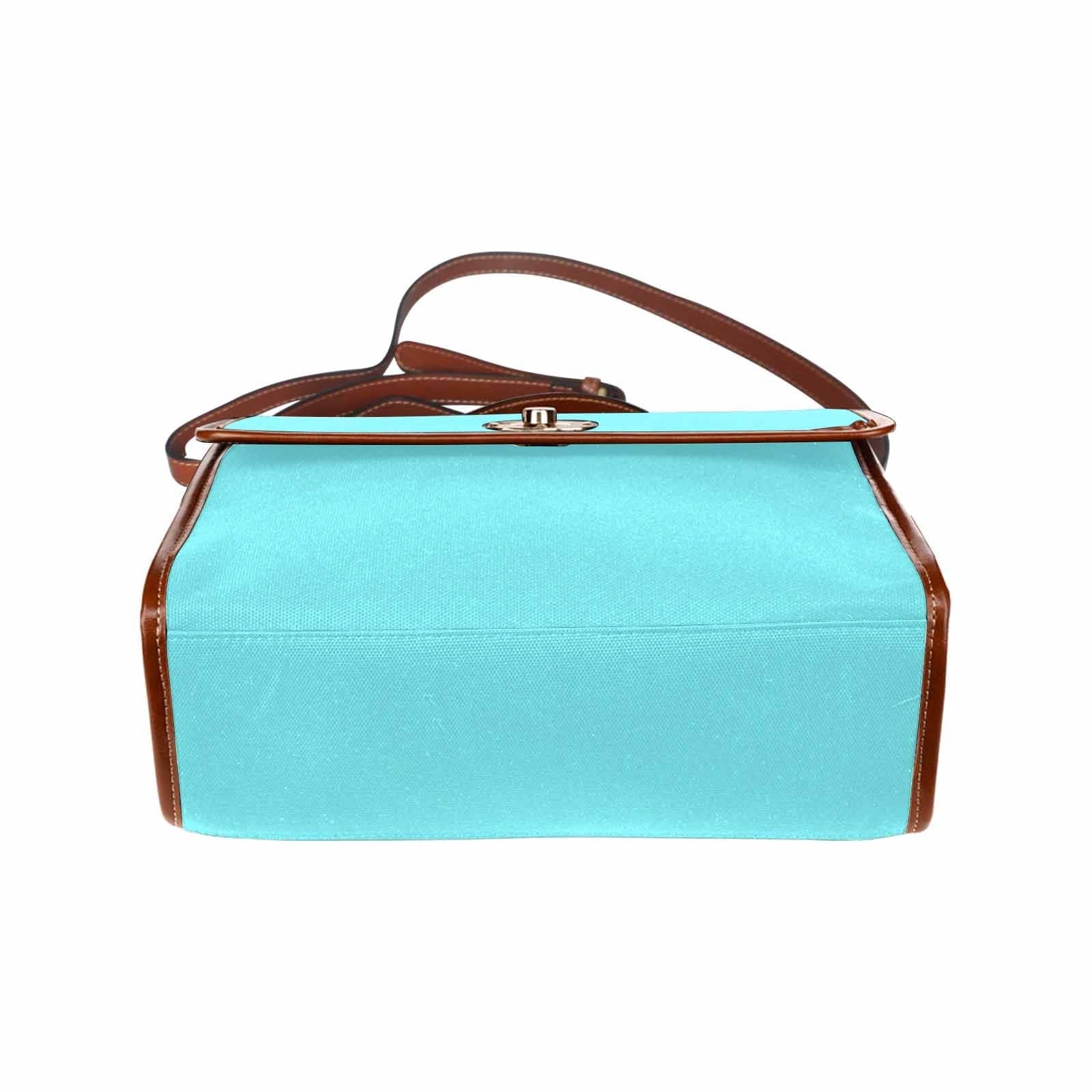 Electric blue canvas handbag with brown crossbody strap, featuring two interior pockets and a zipper pocket.