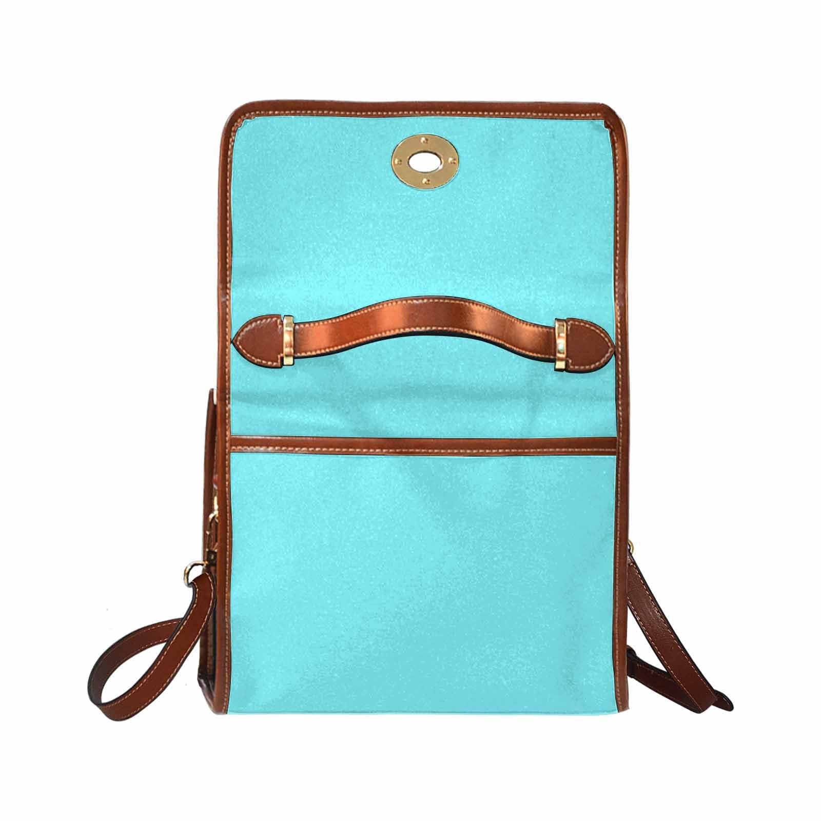 Electric blue canvas handbag with brown crossbody strap, featuring two interior pockets and a zipper pocket.