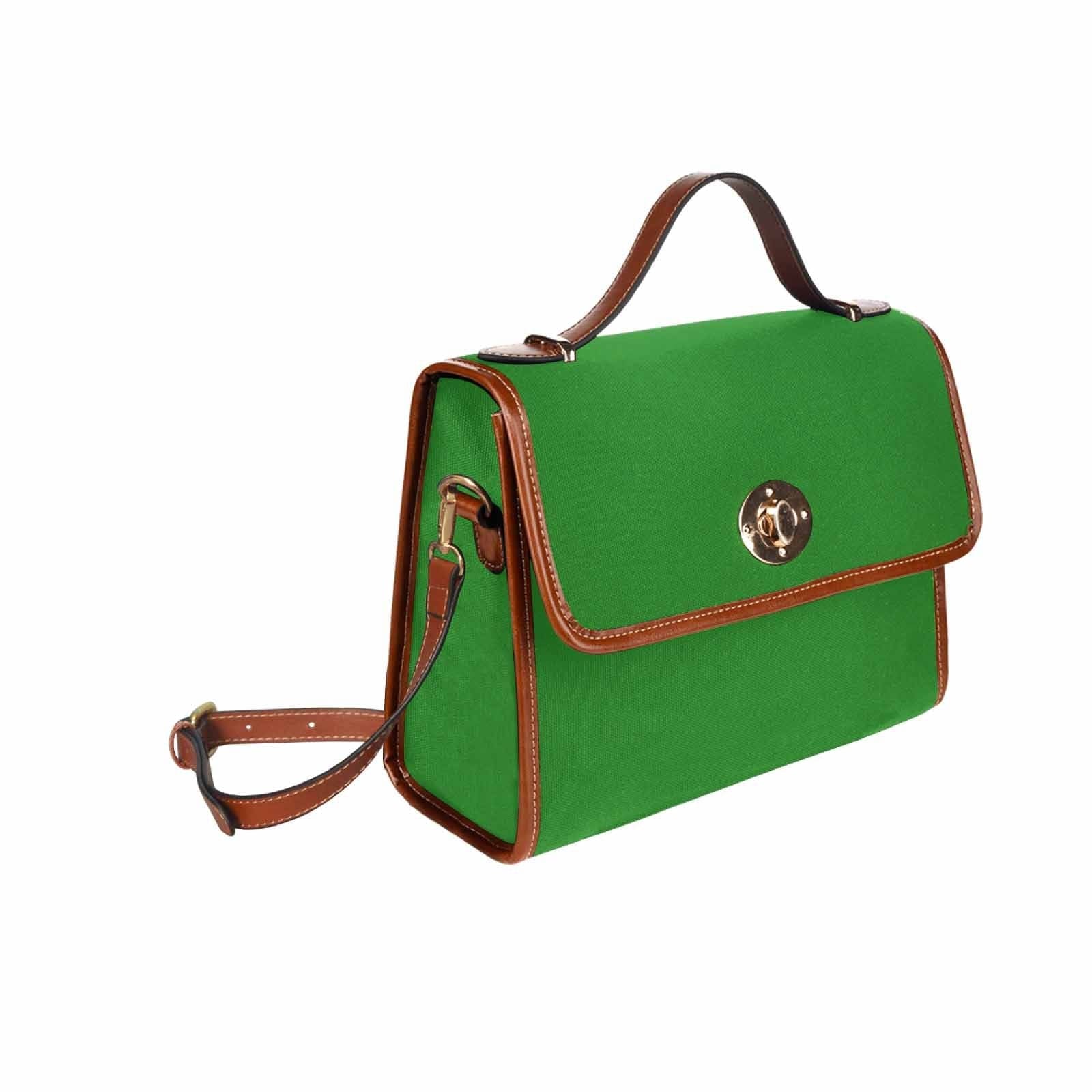 Forest green canvas handbag with brown crossbody strap, featuring two interior pockets and a zipper pocket.