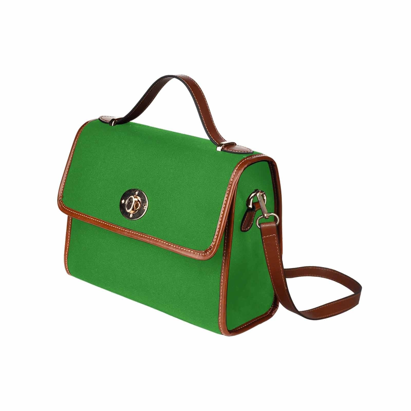 Forest green canvas handbag with brown crossbody strap, featuring two interior pockets and a zipper pocket.