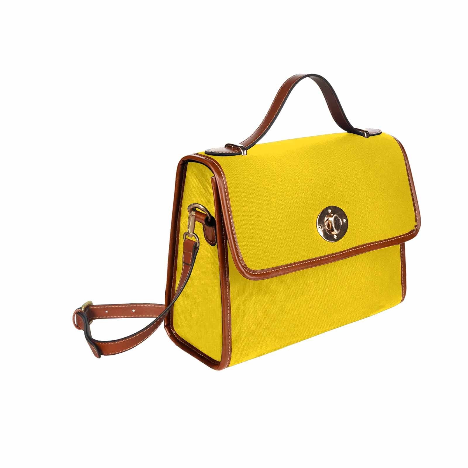 Stylish gold yellow canvas handbag with brown crossbody strap, featuring waterproof material and interior pockets.