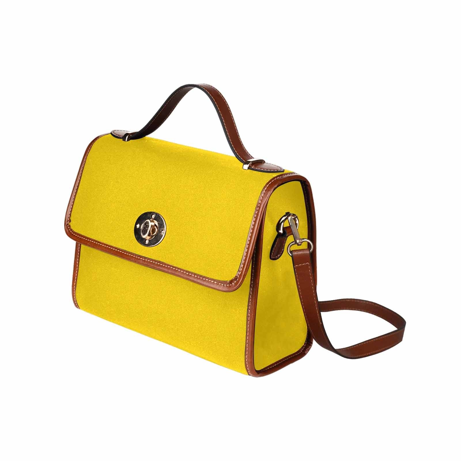 Stylish gold yellow canvas handbag with brown crossbody strap, featuring waterproof material and interior pockets.