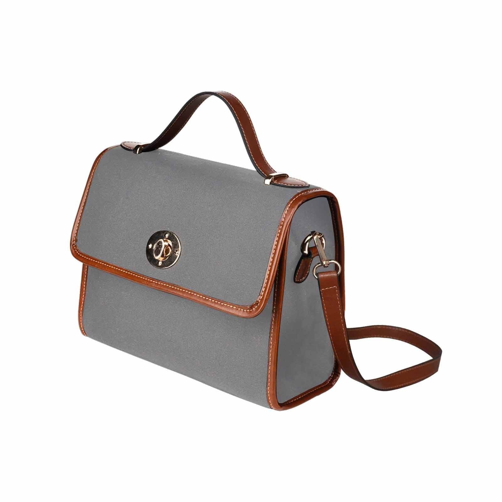 Gray waterproof canvas handbag with brown crossbody strap, featuring two interior pockets and a zipper pocket.