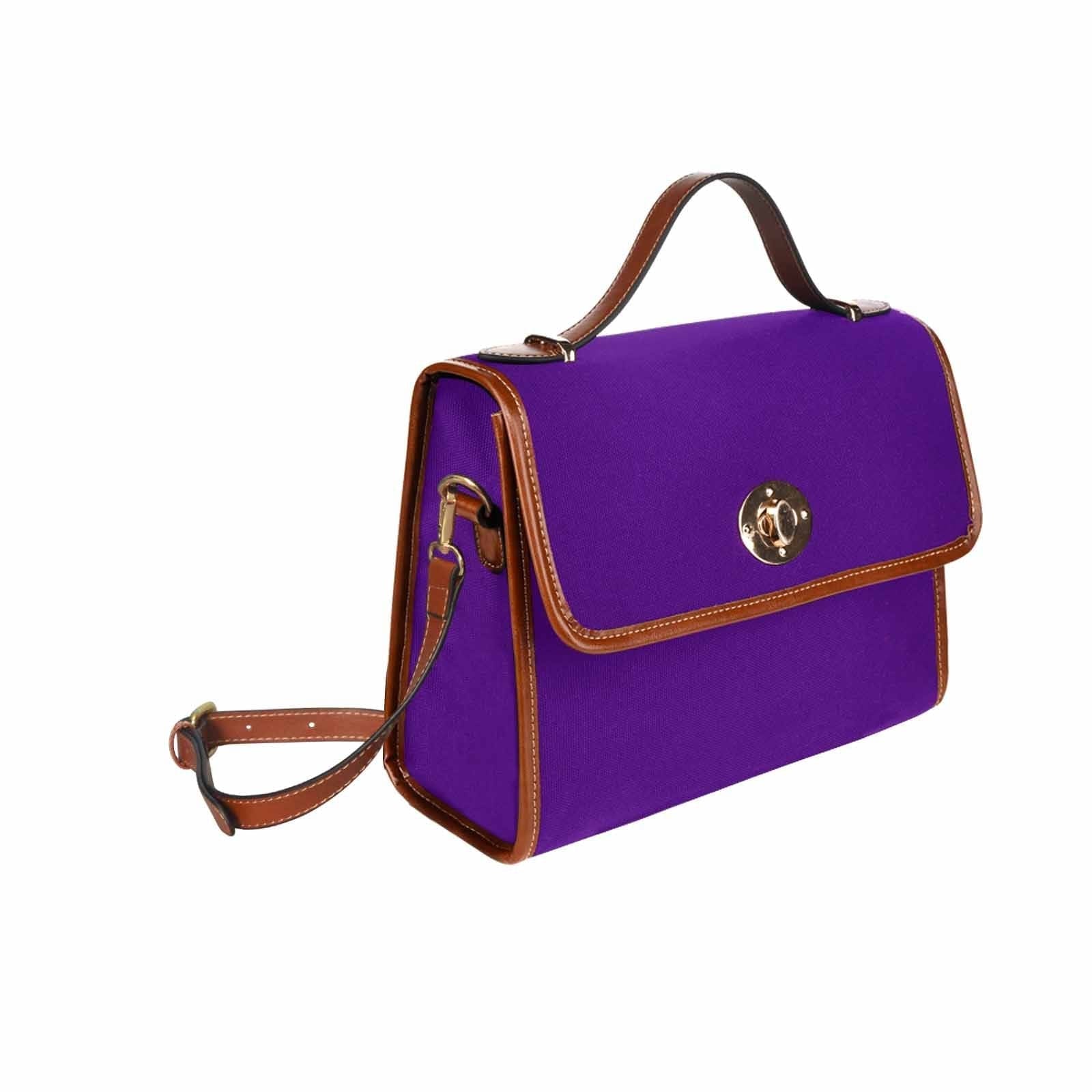 Indigo purple waterproof canvas handbag with brown crossbody strap, featuring two interior pockets and a zipper pocket.