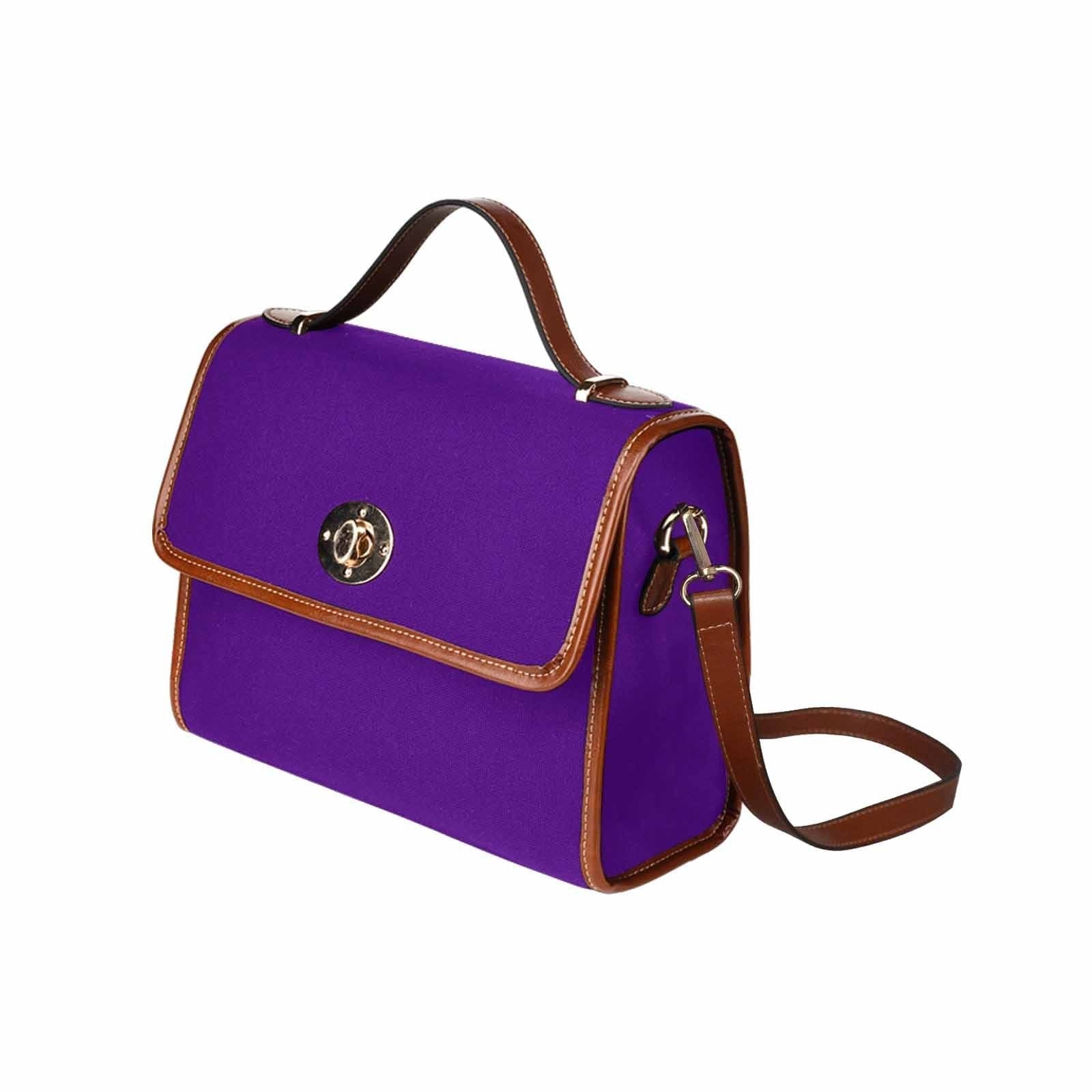 Indigo purple waterproof canvas handbag with brown crossbody strap, featuring two interior pockets and a zipper pocket.