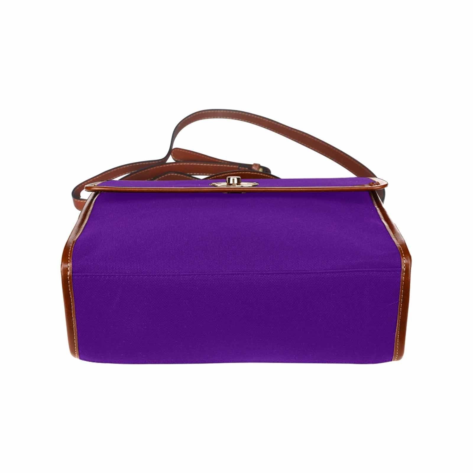 Indigo purple waterproof canvas handbag with brown crossbody strap, featuring two interior pockets and a zipper pocket.