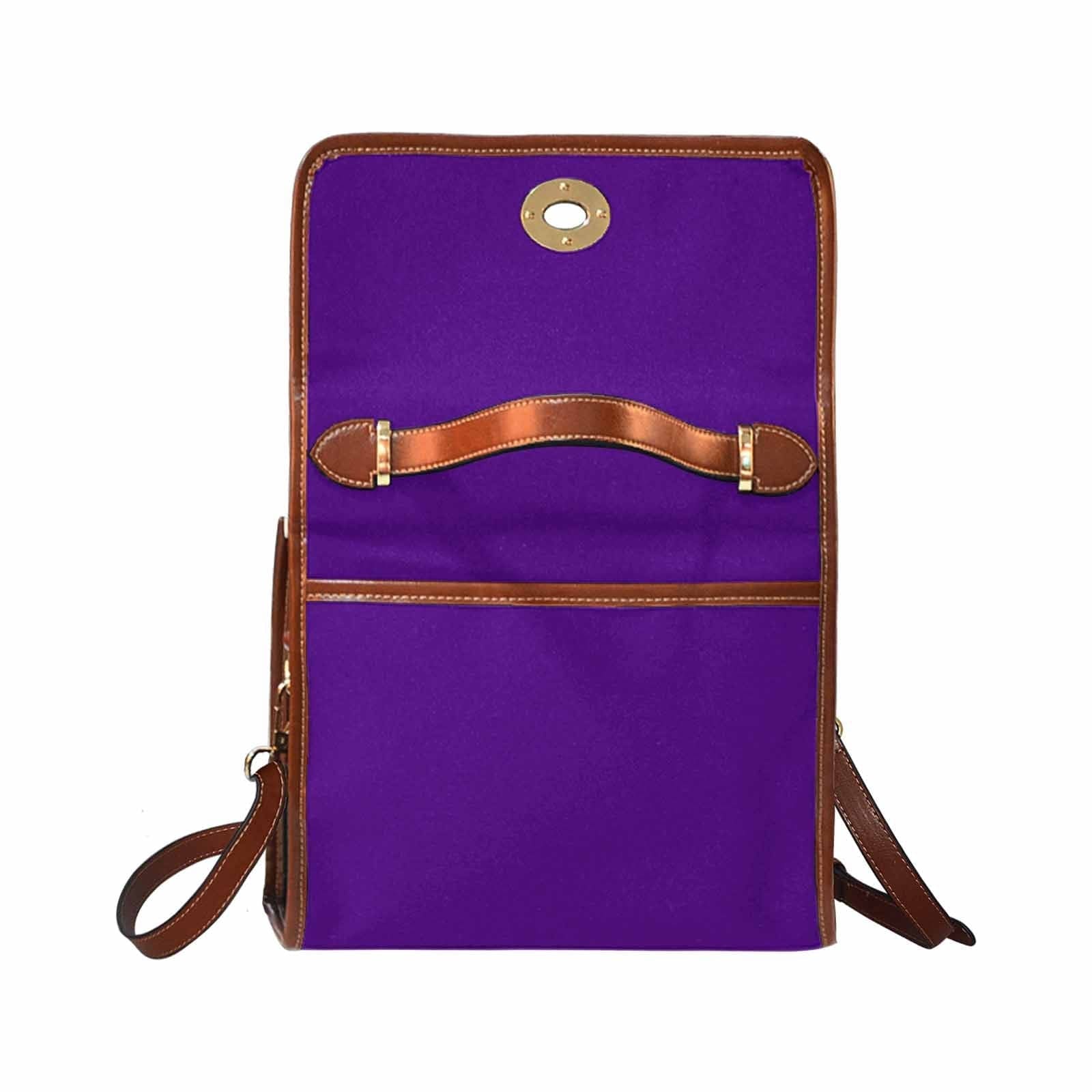 Indigo purple waterproof canvas handbag with brown crossbody strap, featuring two interior pockets and a zipper pocket.