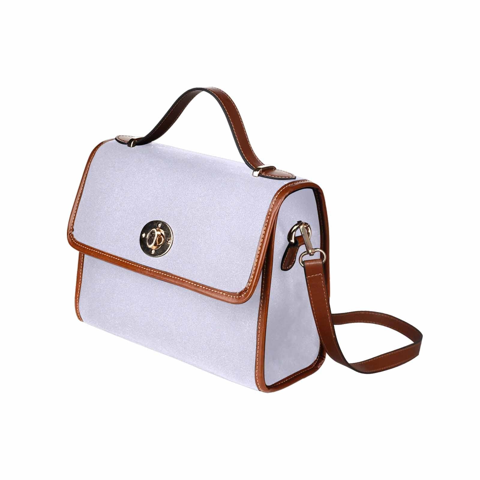 Lavender purple canvas handbag with brown crossbody strap, showcasing its stylish design and functional pockets.