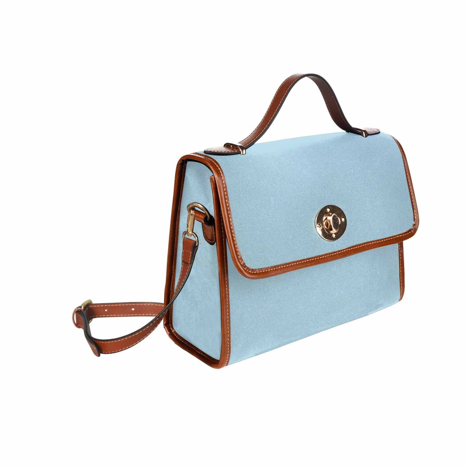 Light blue waterproof canvas handbag with brown crossbody strap, featuring two interior pockets and a zipper pocket.