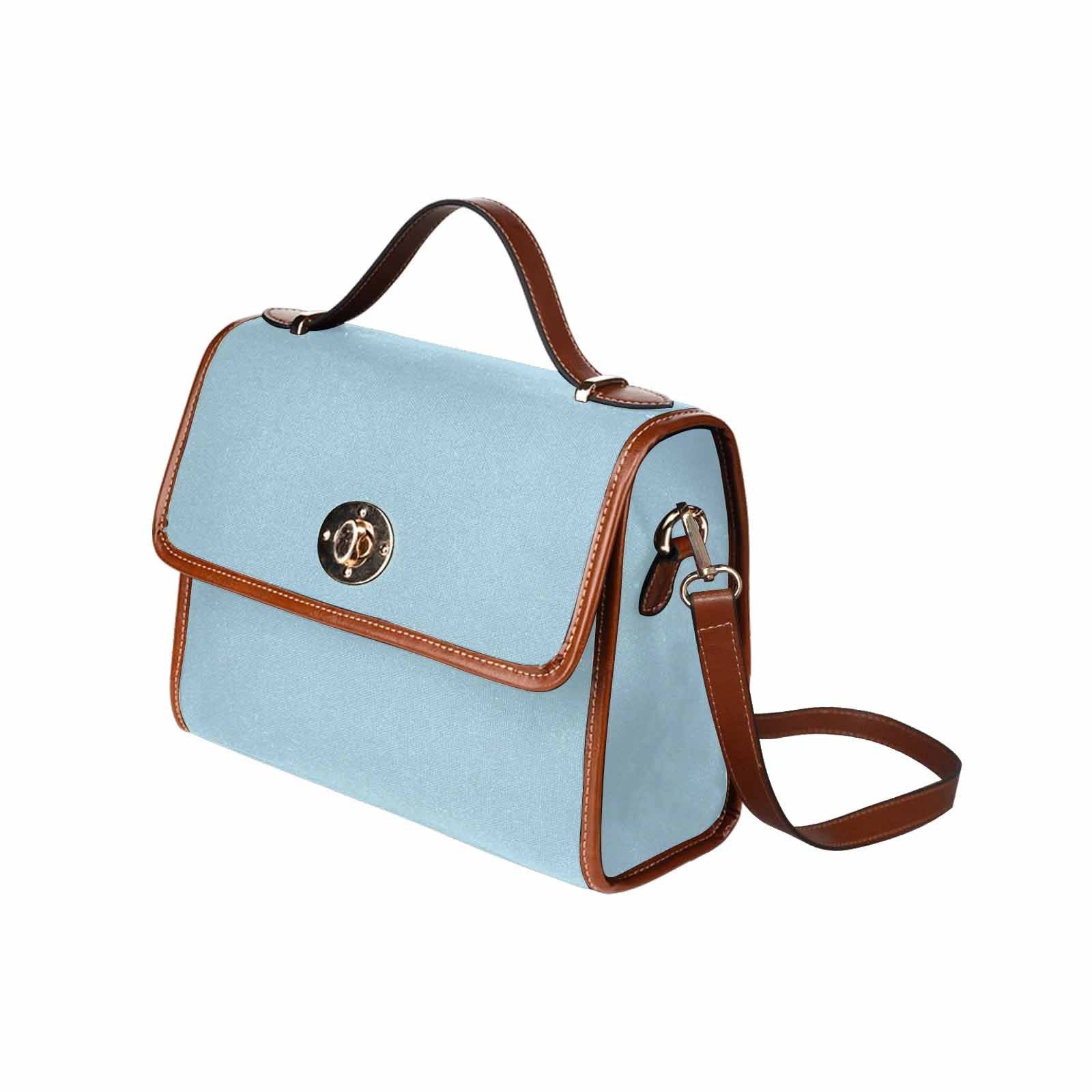 Light blue waterproof canvas handbag with brown crossbody strap, featuring two interior pockets and a zipper pocket.