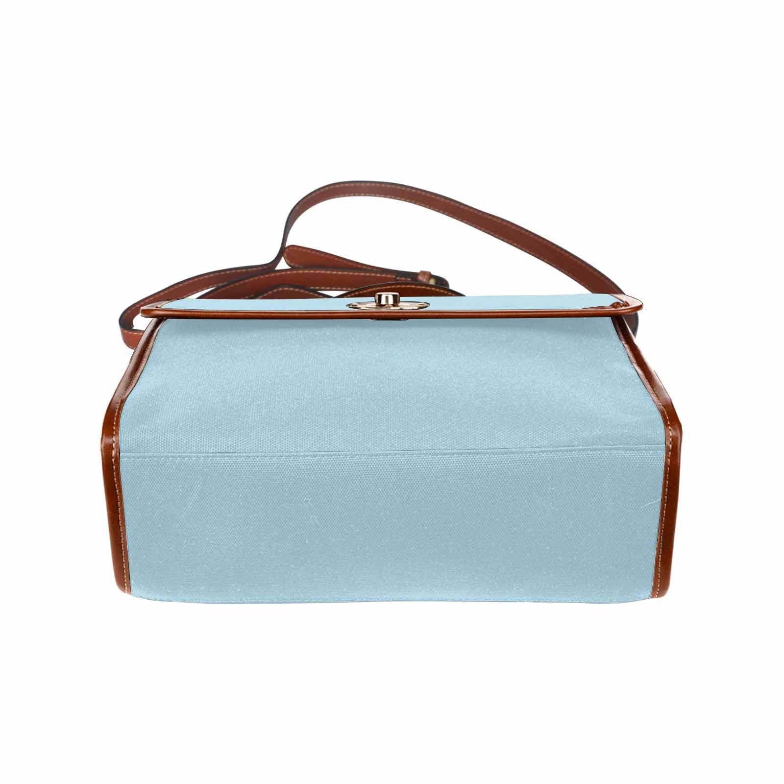 Light blue waterproof canvas handbag with brown crossbody strap, featuring two interior pockets and a zipper pocket.