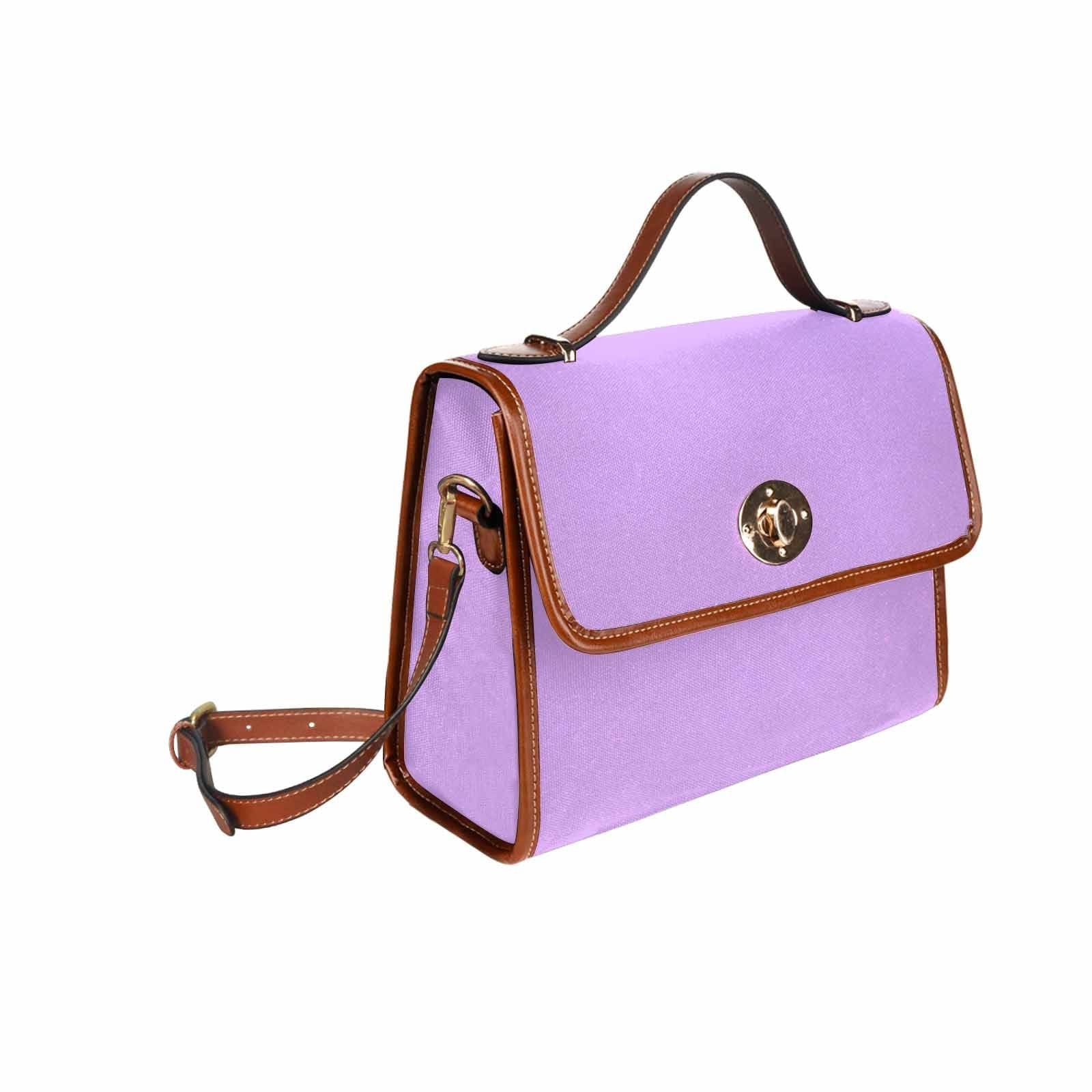 Mauve purple canvas handbag with brown crossbody strap, featuring two interior pockets and a zipper pocket.