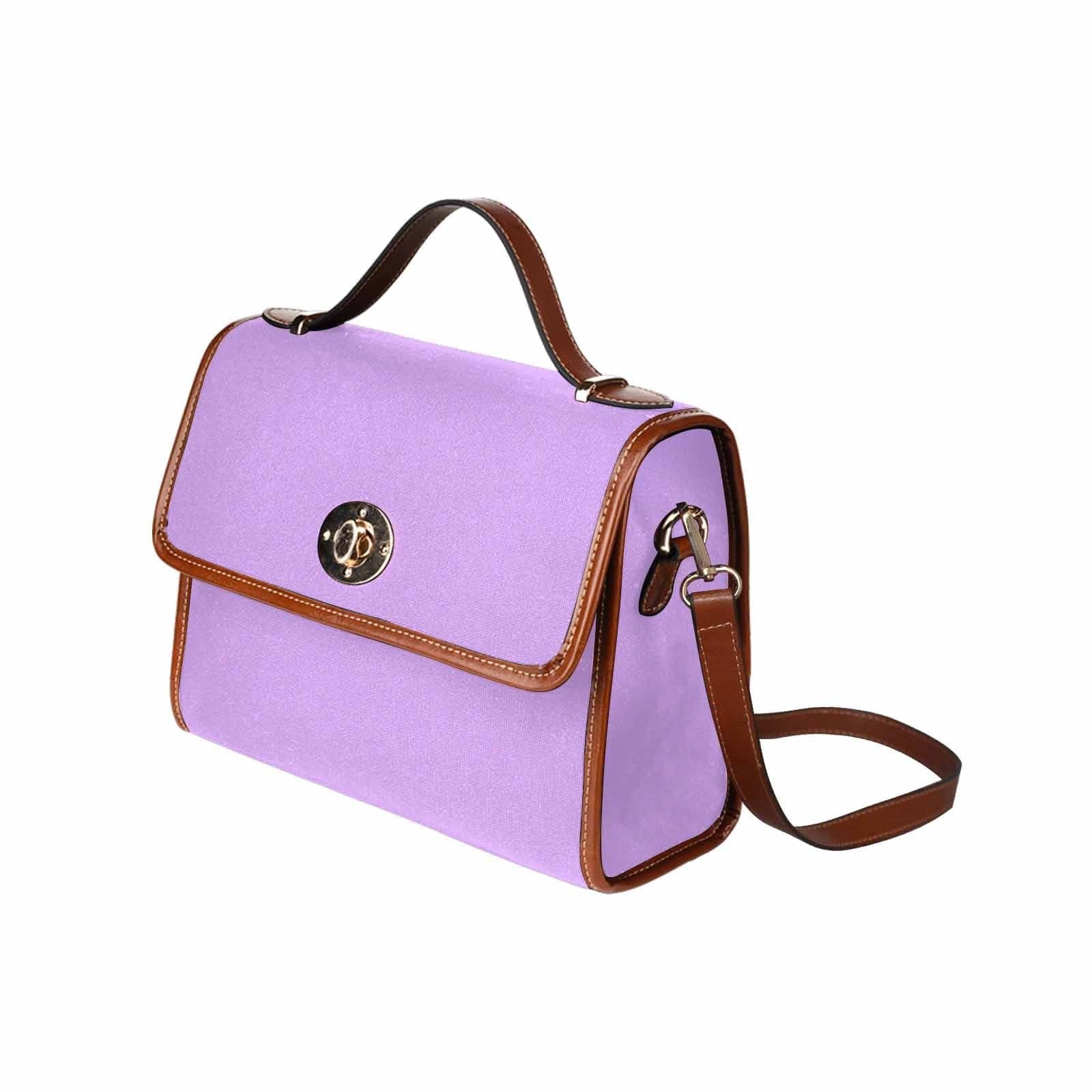 Mauve purple canvas handbag with brown crossbody strap, featuring two interior pockets and a zipper pocket.