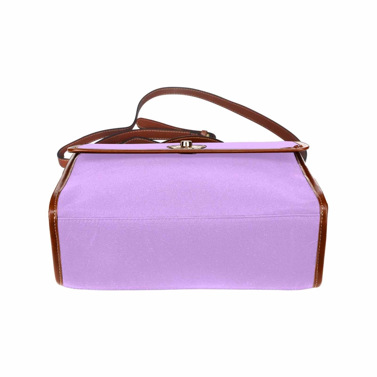 Mauve purple canvas handbag with brown crossbody strap, featuring two interior pockets and a zipper pocket.