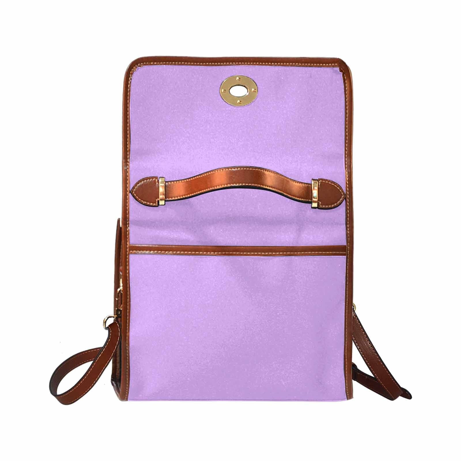 Mauve purple canvas handbag with brown crossbody strap, featuring two interior pockets and a zipper pocket.