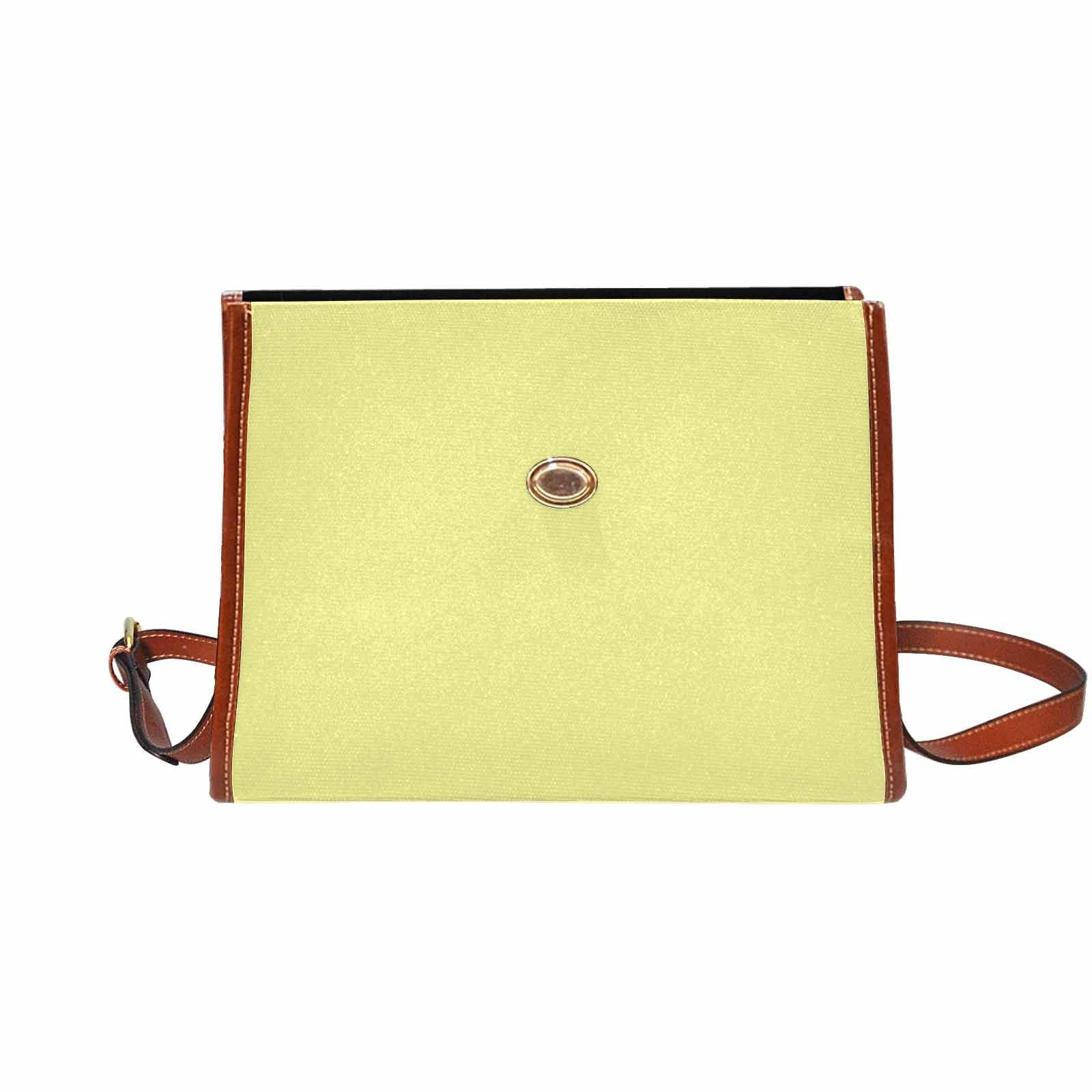 Pastel yellow canvas handbag with a brown crossbody strap, featuring two interior pockets and a zipper pocket.