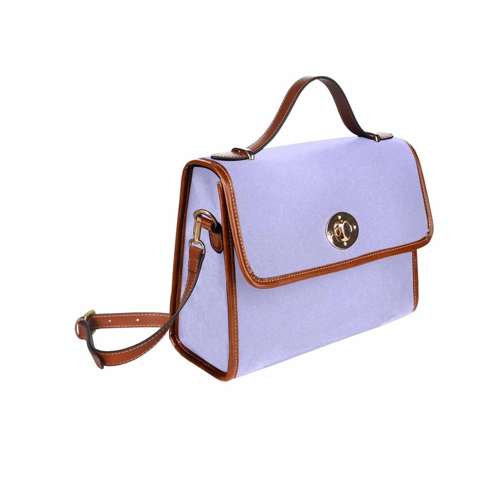 Stylish periwinkle purple canvas handbag with brown crossbody strap, showcasing its durable design and spacious interior.