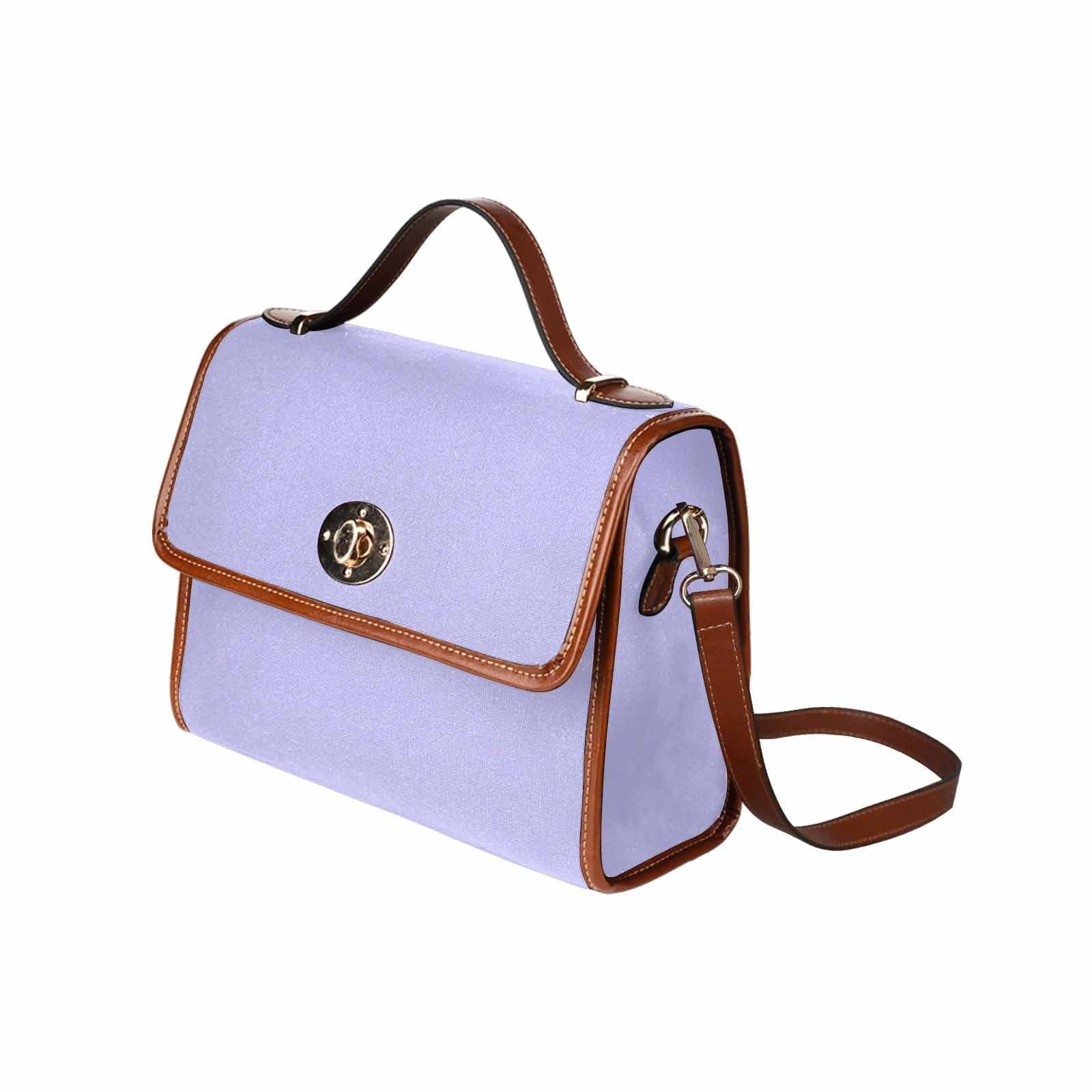 Stylish periwinkle purple canvas handbag with brown crossbody strap, showcasing its durable design and spacious interior.