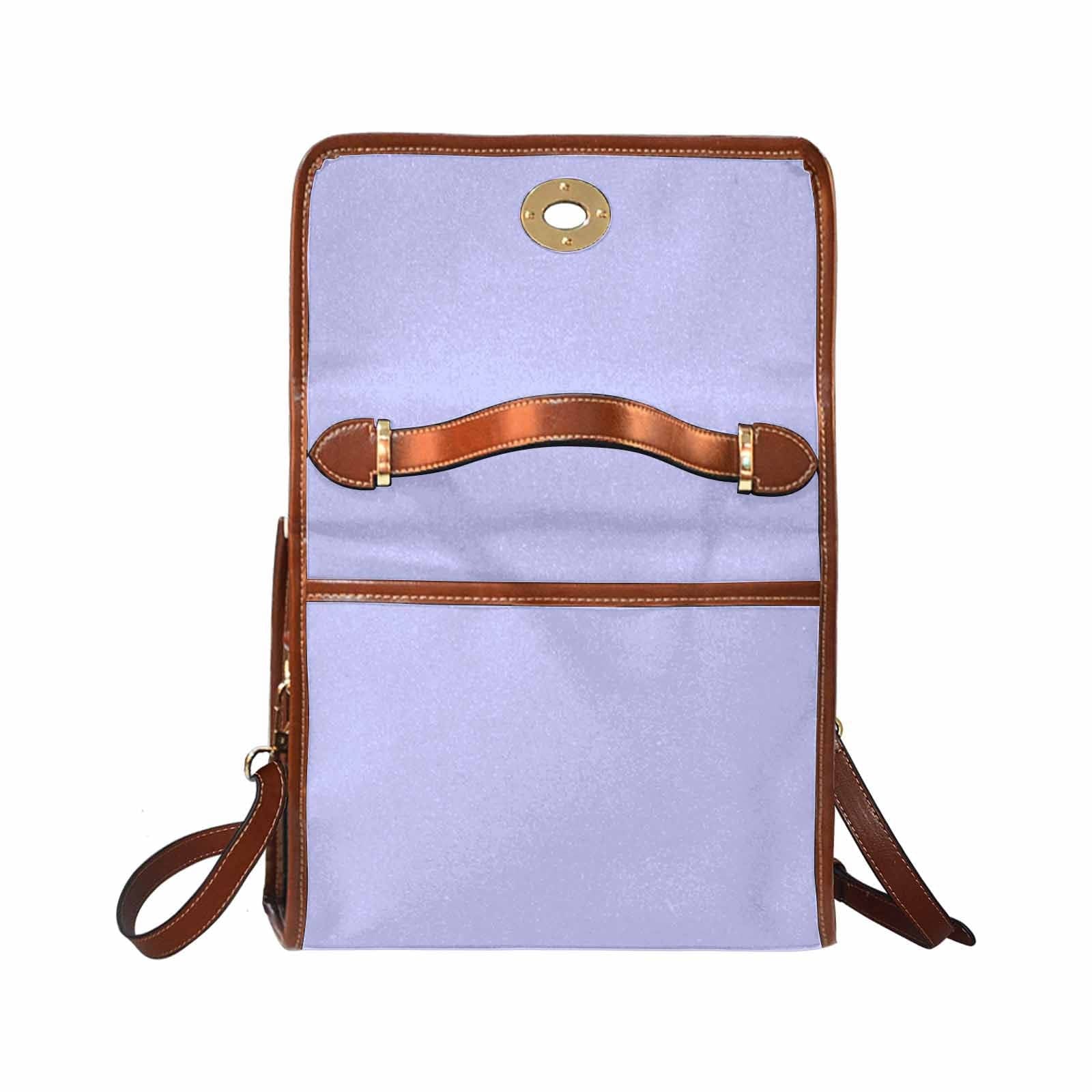 Stylish periwinkle purple canvas handbag with brown crossbody strap, showcasing its durable design and spacious interior.