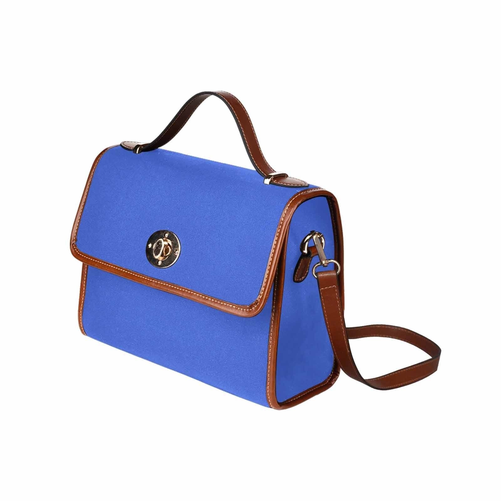 Royal Blue Canvas Handbag with brown crossbody strap, showcasing its waterproof material and stylish design.