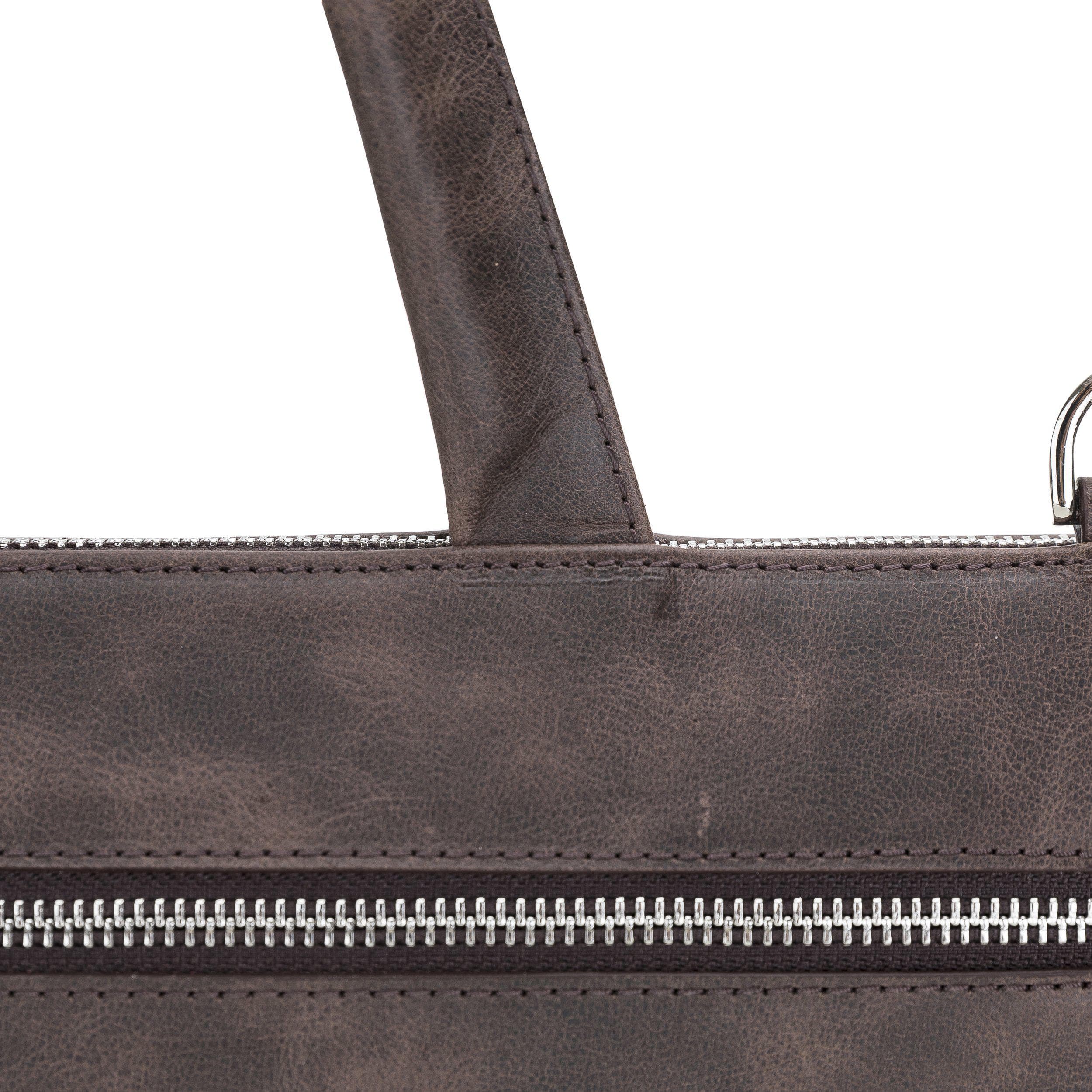 Canzo Leather Notebook Bag made from 100% genuine calf leather, featuring a zippered main compartment and adjustable shoulder straps.