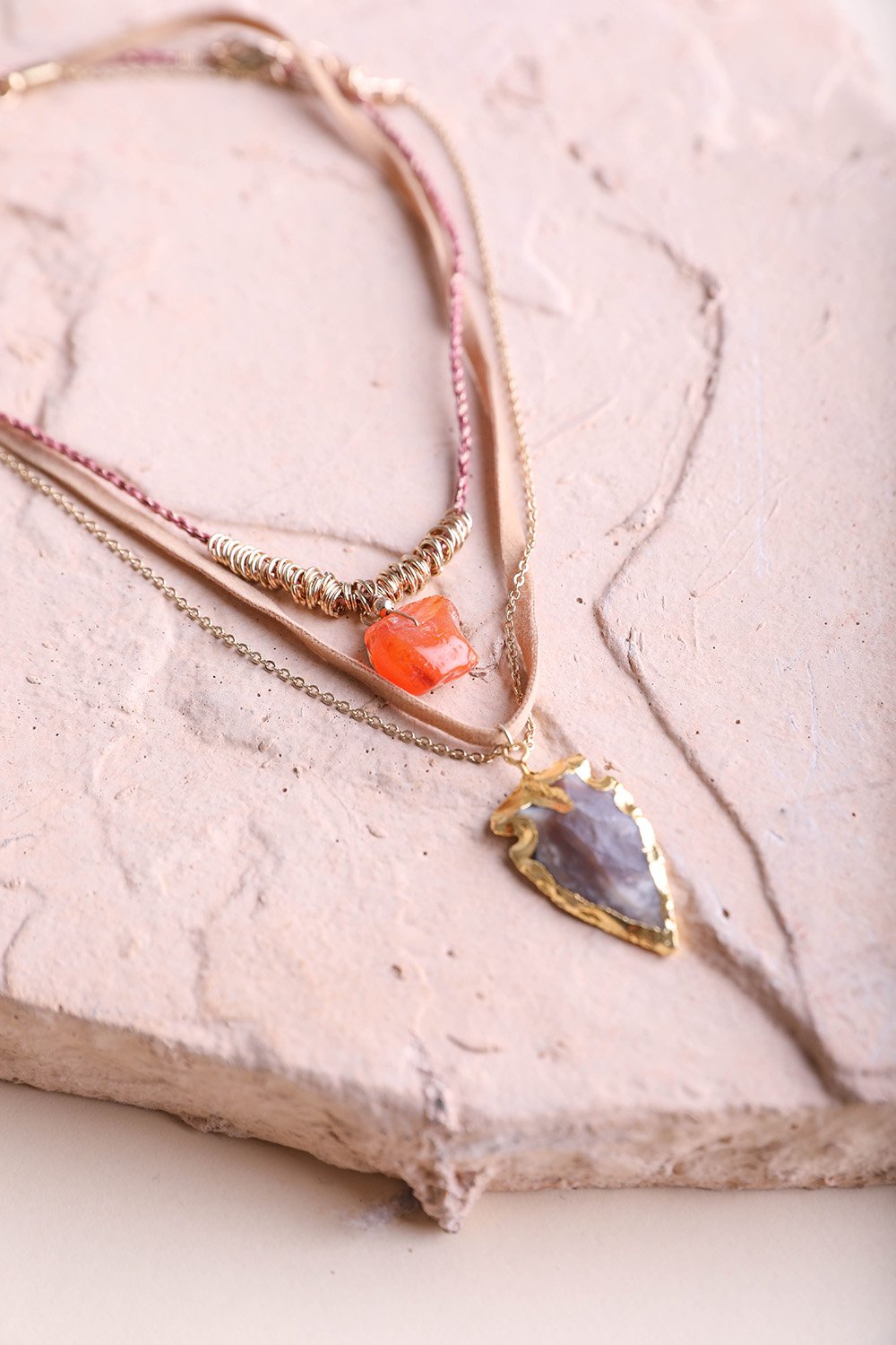 Carnelian and brown agate suede necklace with gold chain, showcasing vibrant gemstones and bohemian style.